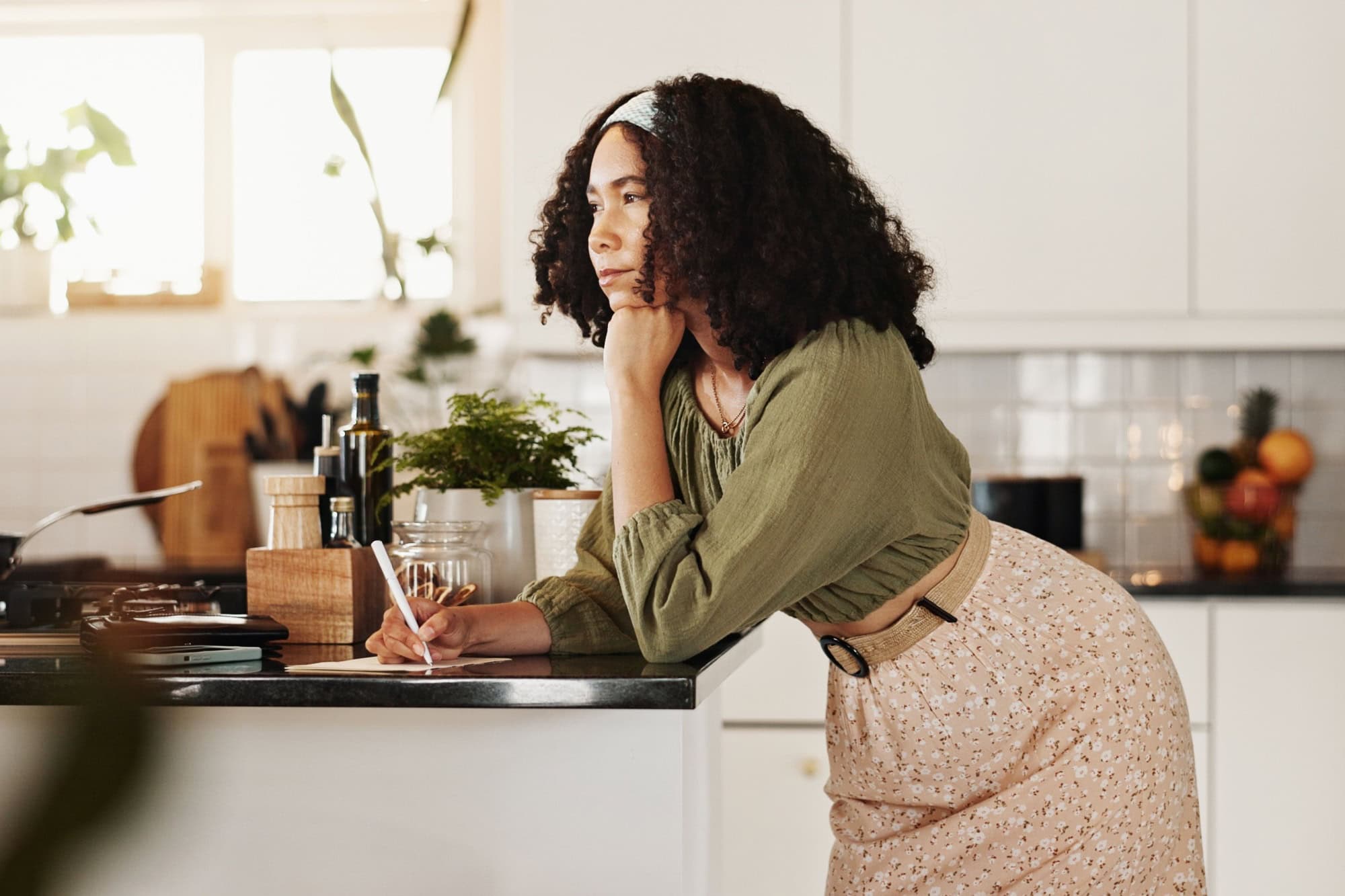 Cooking, kitchen and woman with notebook, ideas and planning for recipe, thinking or writing in home. Meal prep, morning and person with info for ingredients, contemplating or research of instruction