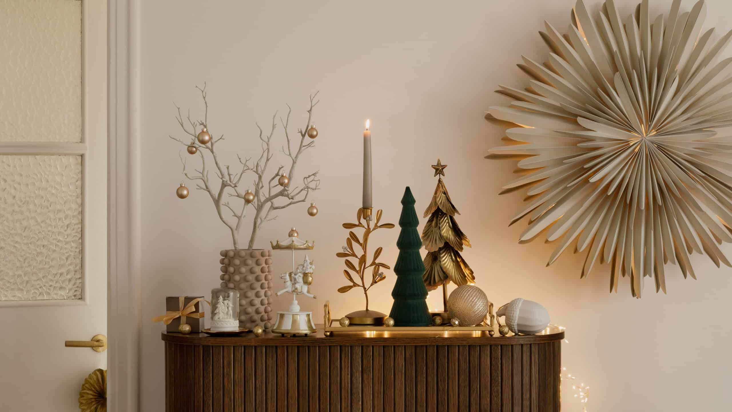Elegant holiday decor with gold accents, candlelight, and festive trees. A warm and stylish setup perfect for Christmas celebrations.