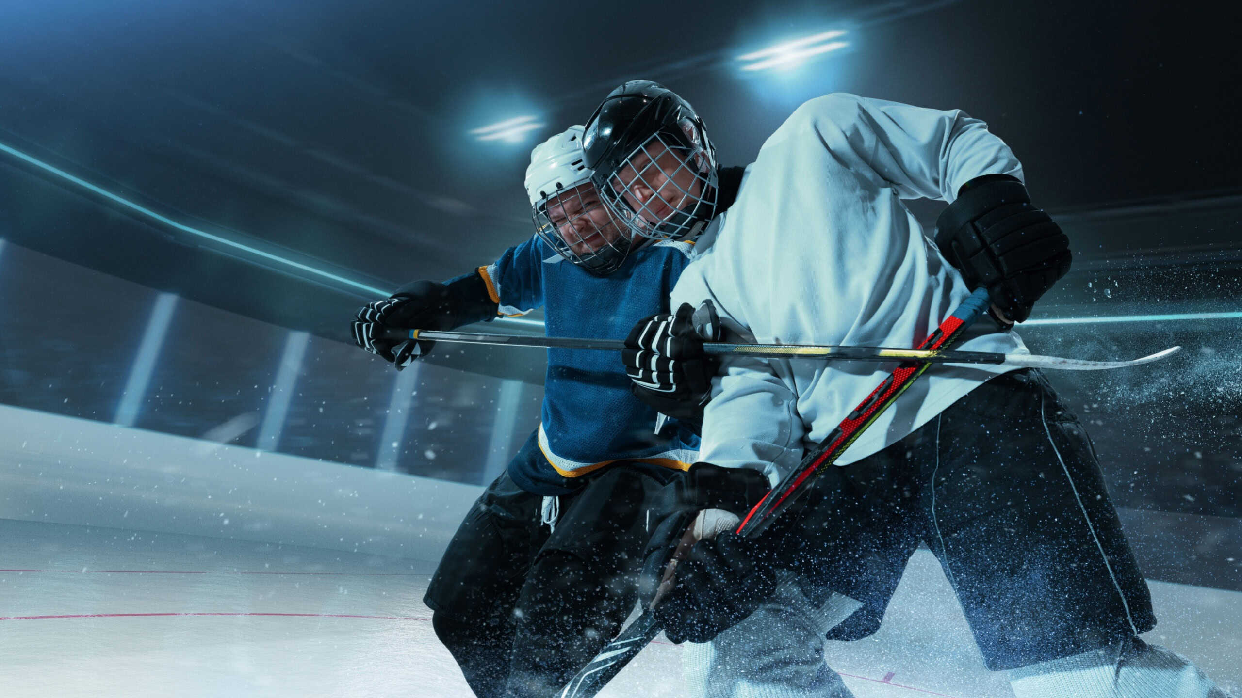 Two professional ice hockey players in full gear fiercely competing for puck control on 3D ice rink. Concept of professional training, sportsmanship and competitive spirit