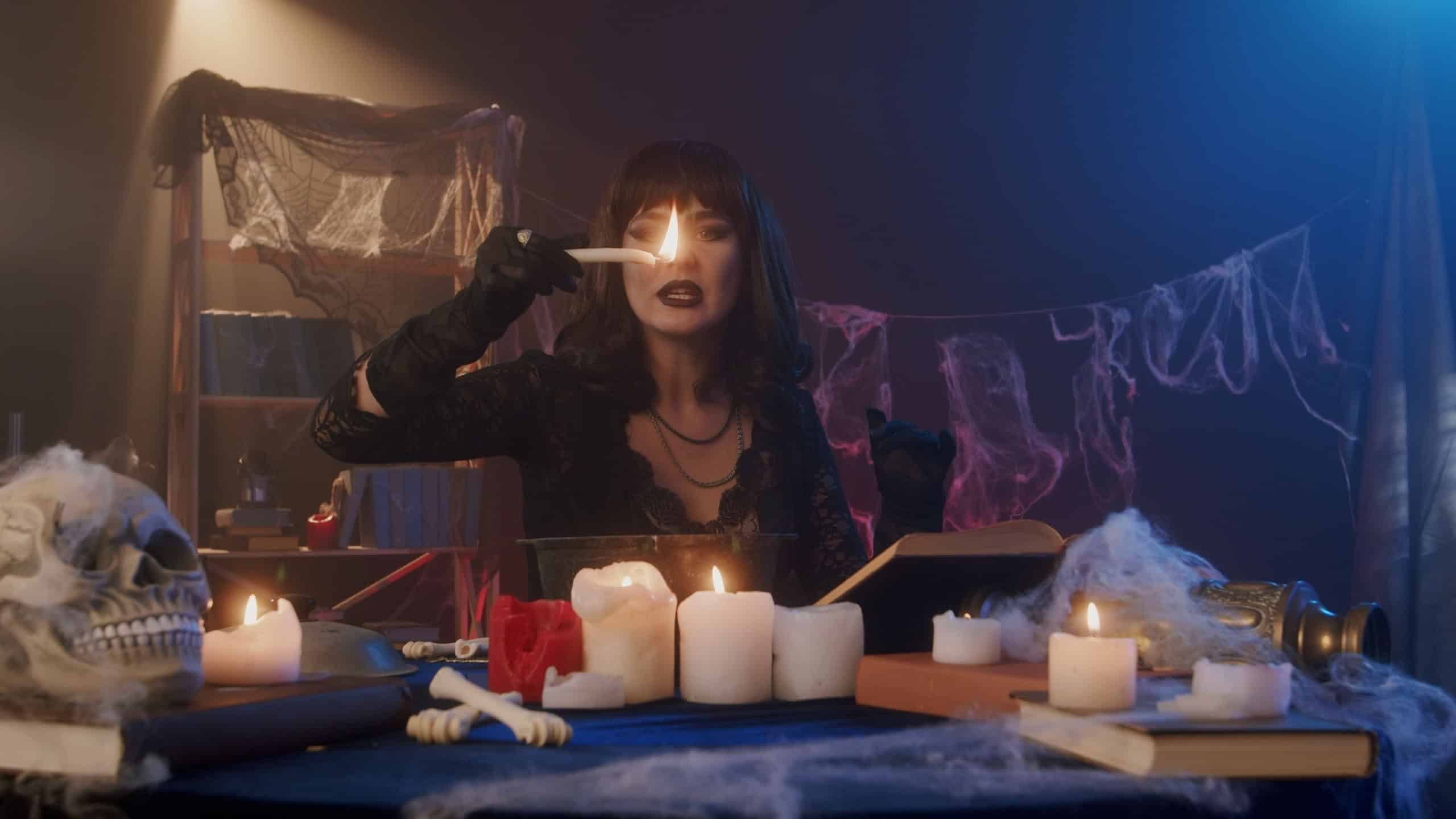 Mysterious Woman Performing a Candle Ritual Surrounded by Skulls