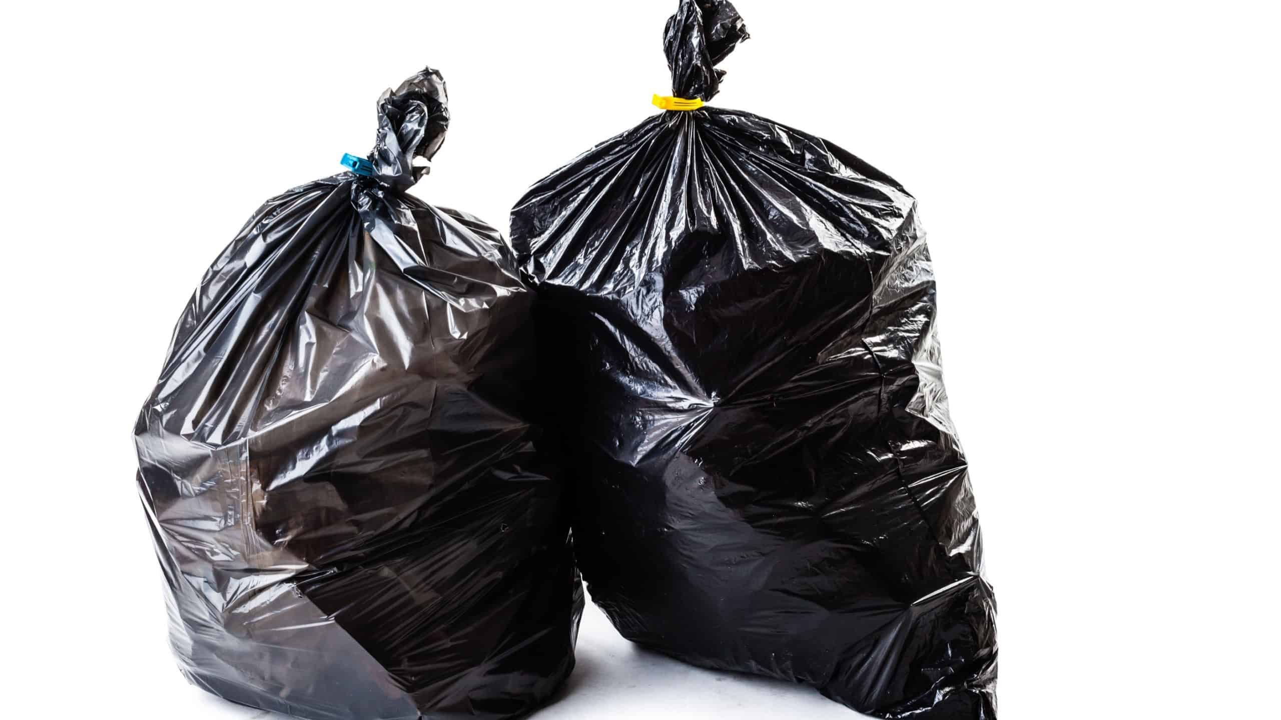 A black garbage bag isolated over a white background