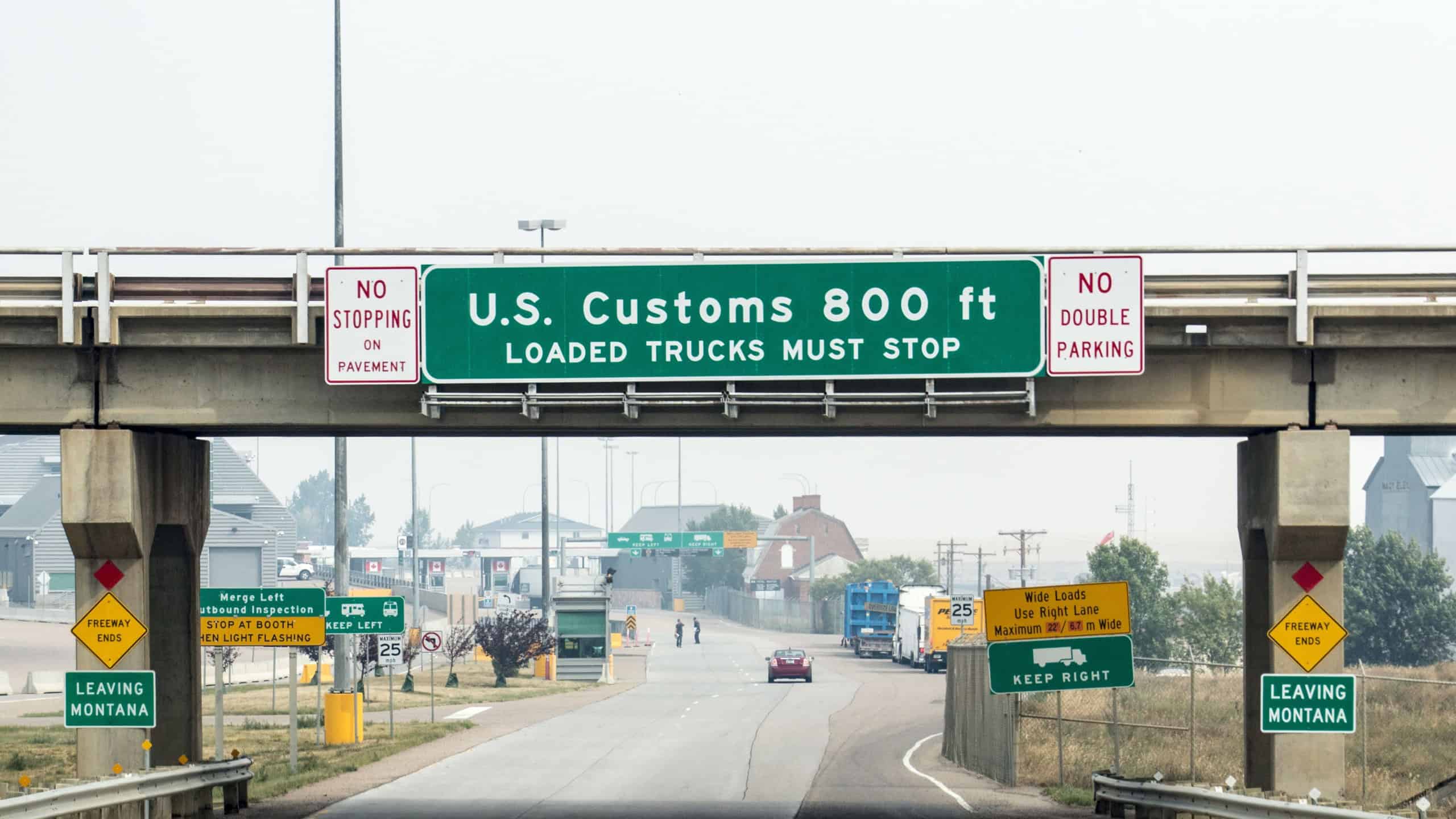 Signs indicate that drivers are approaching the U.S. Customs area in Sweet Grass, Montana near the Canadian border