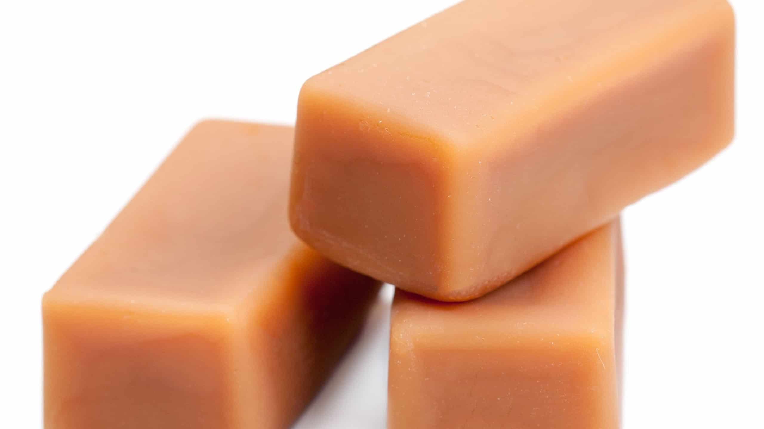 Toffee caramel candies chunks close-up isolated on white background