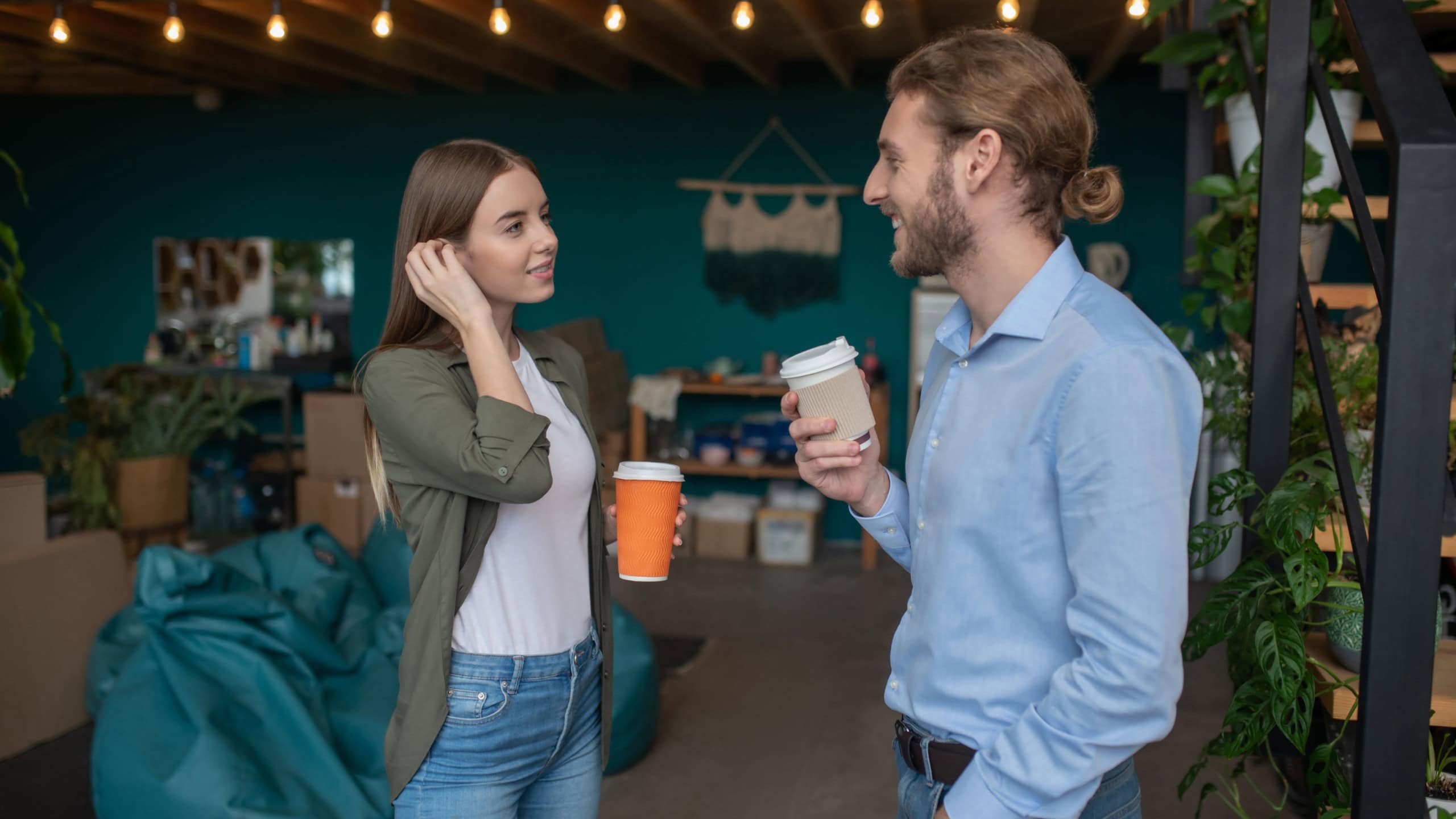 Small talk. A man and a woman chatting and drinking coffee