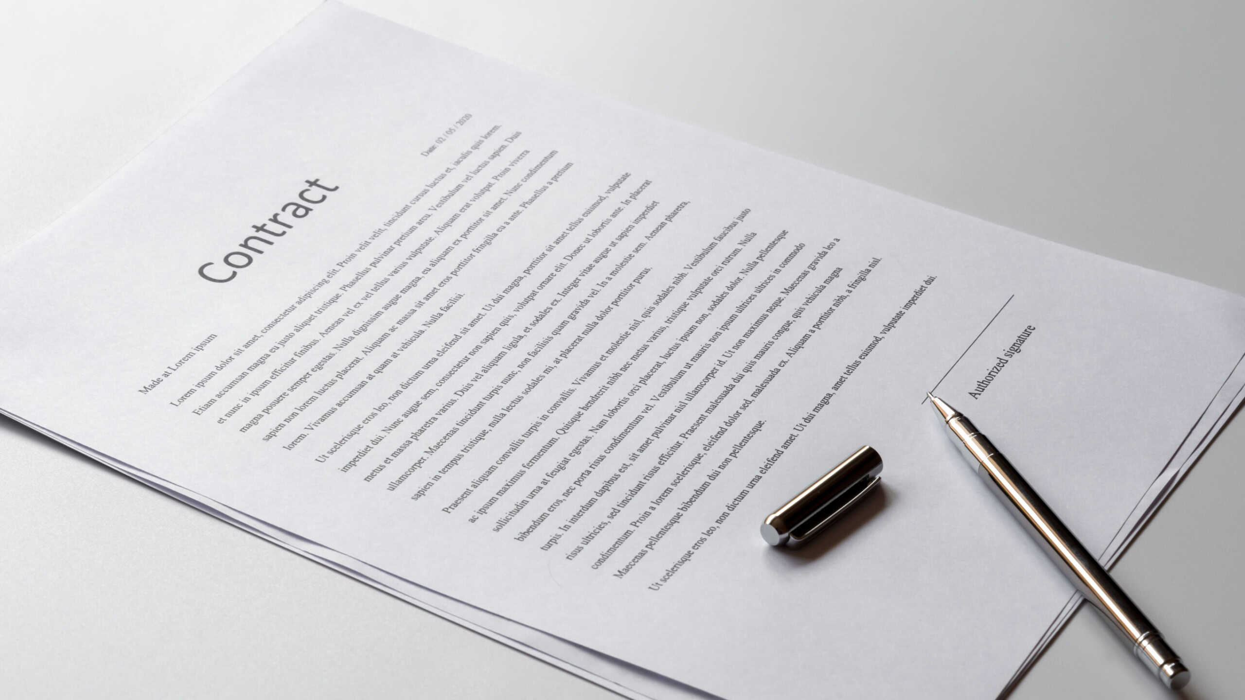 White table with paper contract detail and empty space to sign authorized signature