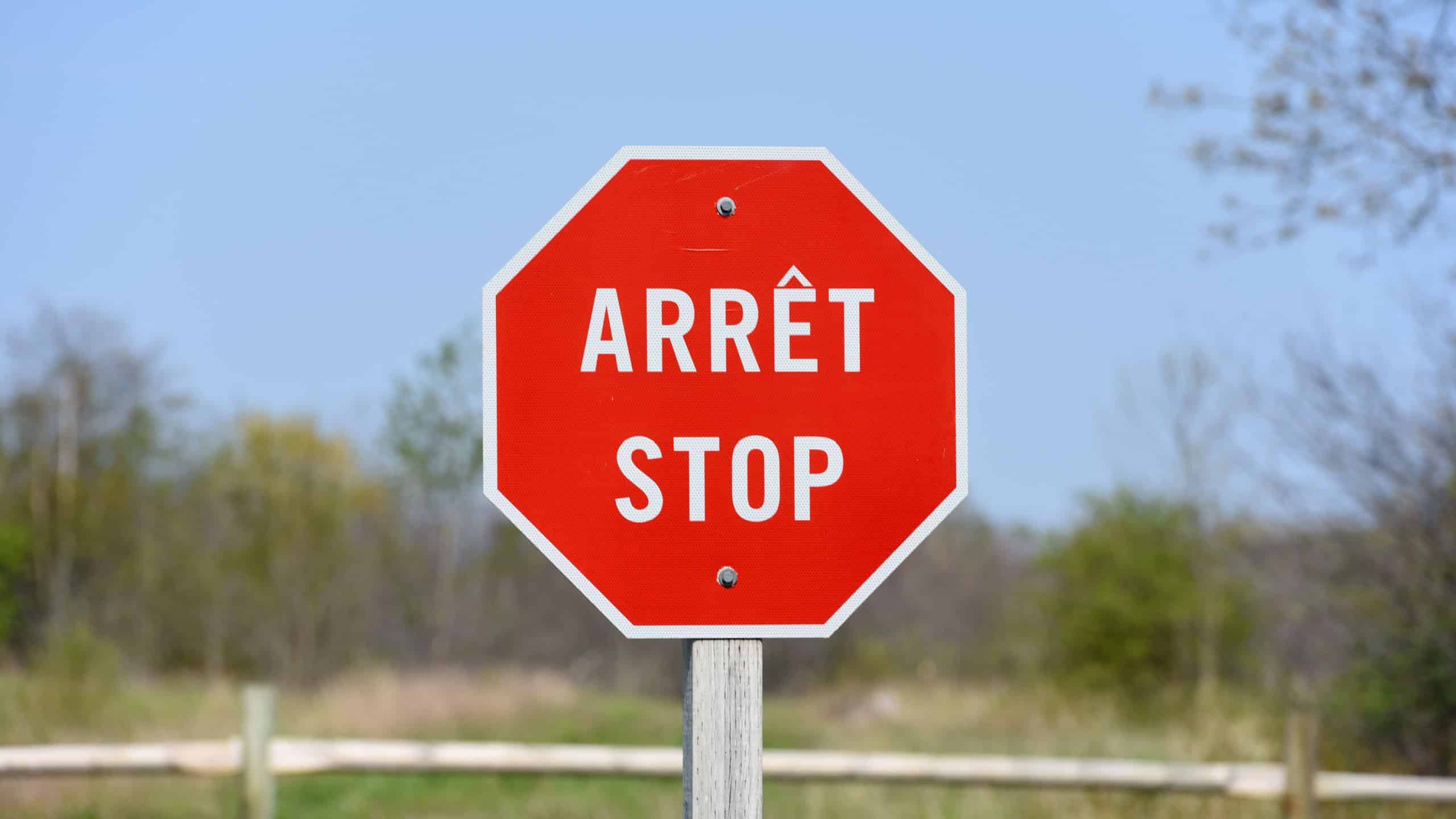 Bilingual Stop Sign with French Arret at the top and English Stop at the bottom