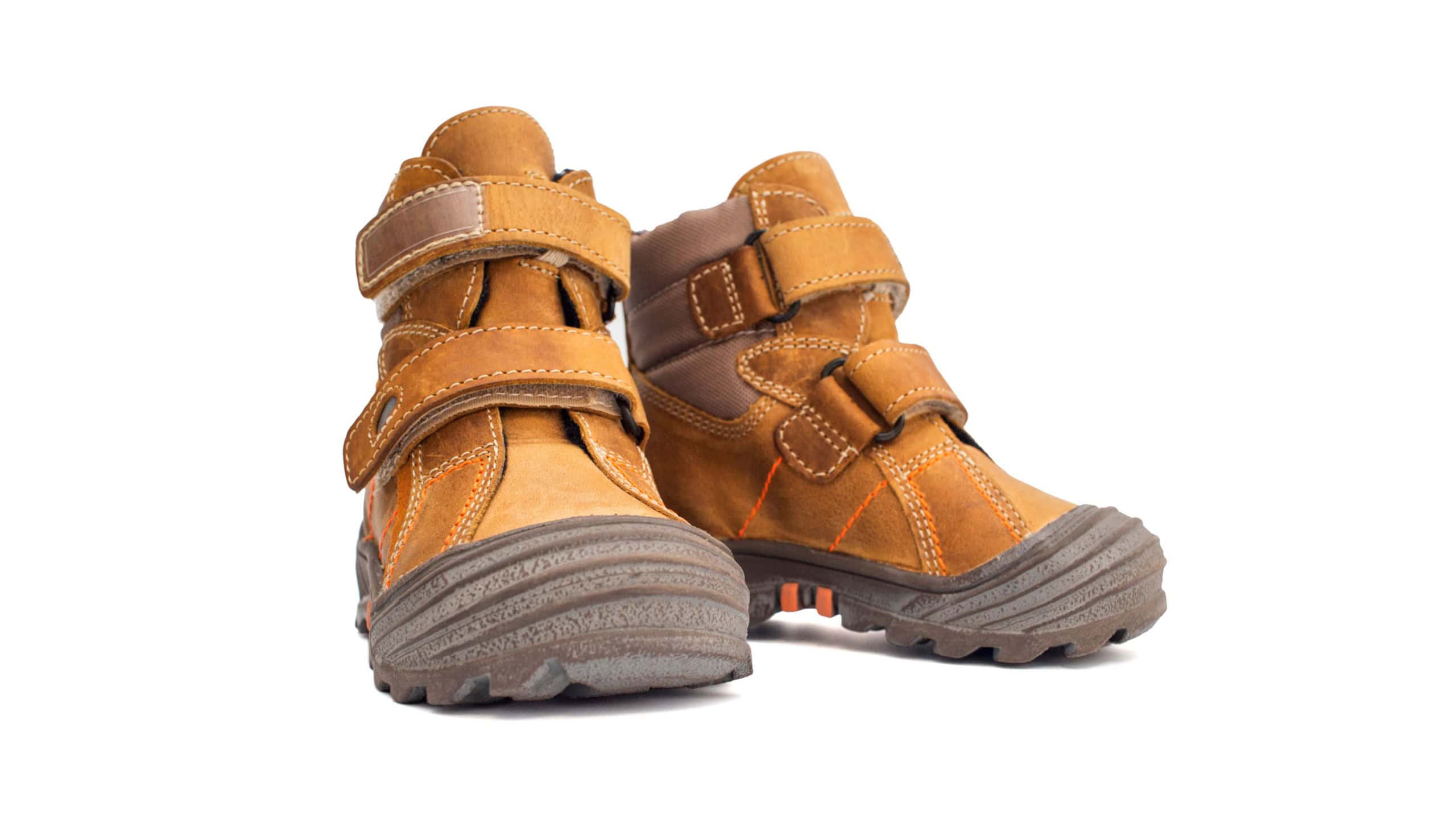 Yellow child boots from natural leather isolated on white background. Trendy casual shoes, youth style. Concept of advertising autumn winter shoes, sale, shop.