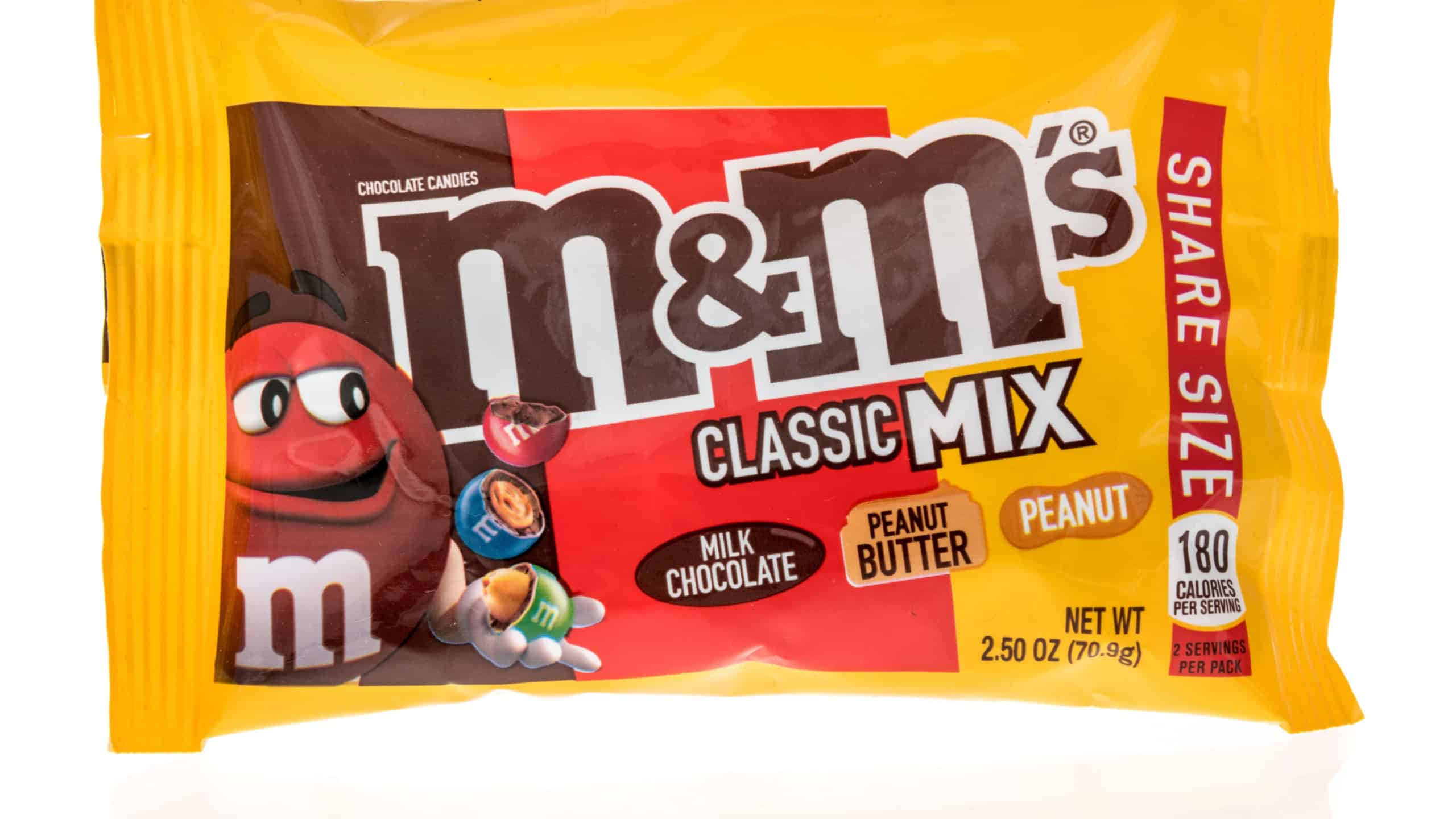 Winneconne, WI -18 July 2021: A package of M M classic mix milk chocolate peanut butter and peanut chocolate canides on an isolated background