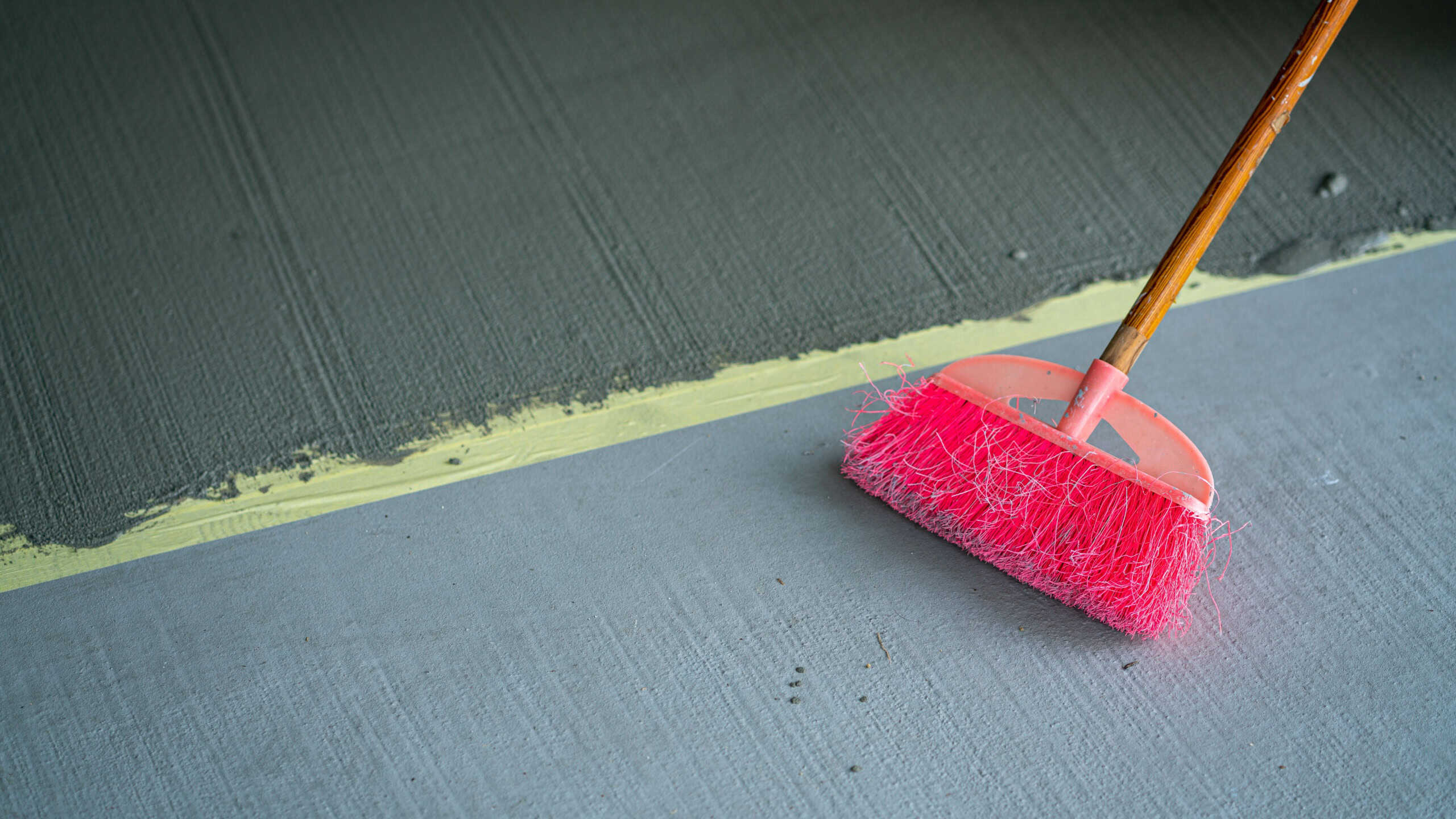 Broom on the floor, fresh cement Construction and renovations