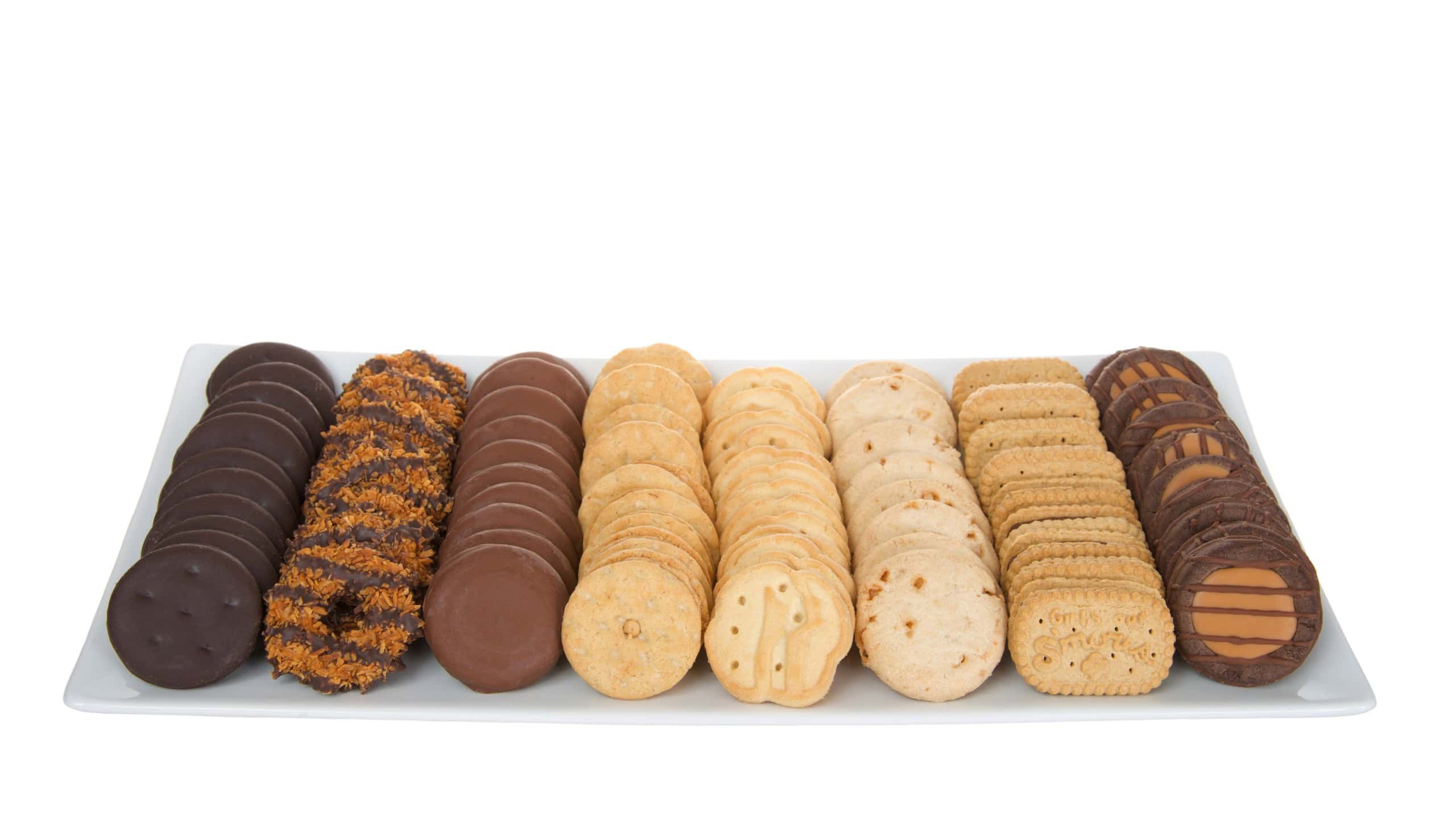 Alameda, CA - Feb 24, 2022: White rectangular plate with eight popular and new Girl Scout cookies made by Little Brownie Bakers. Available annually during Girl Scout cookie sales, isolated on white
