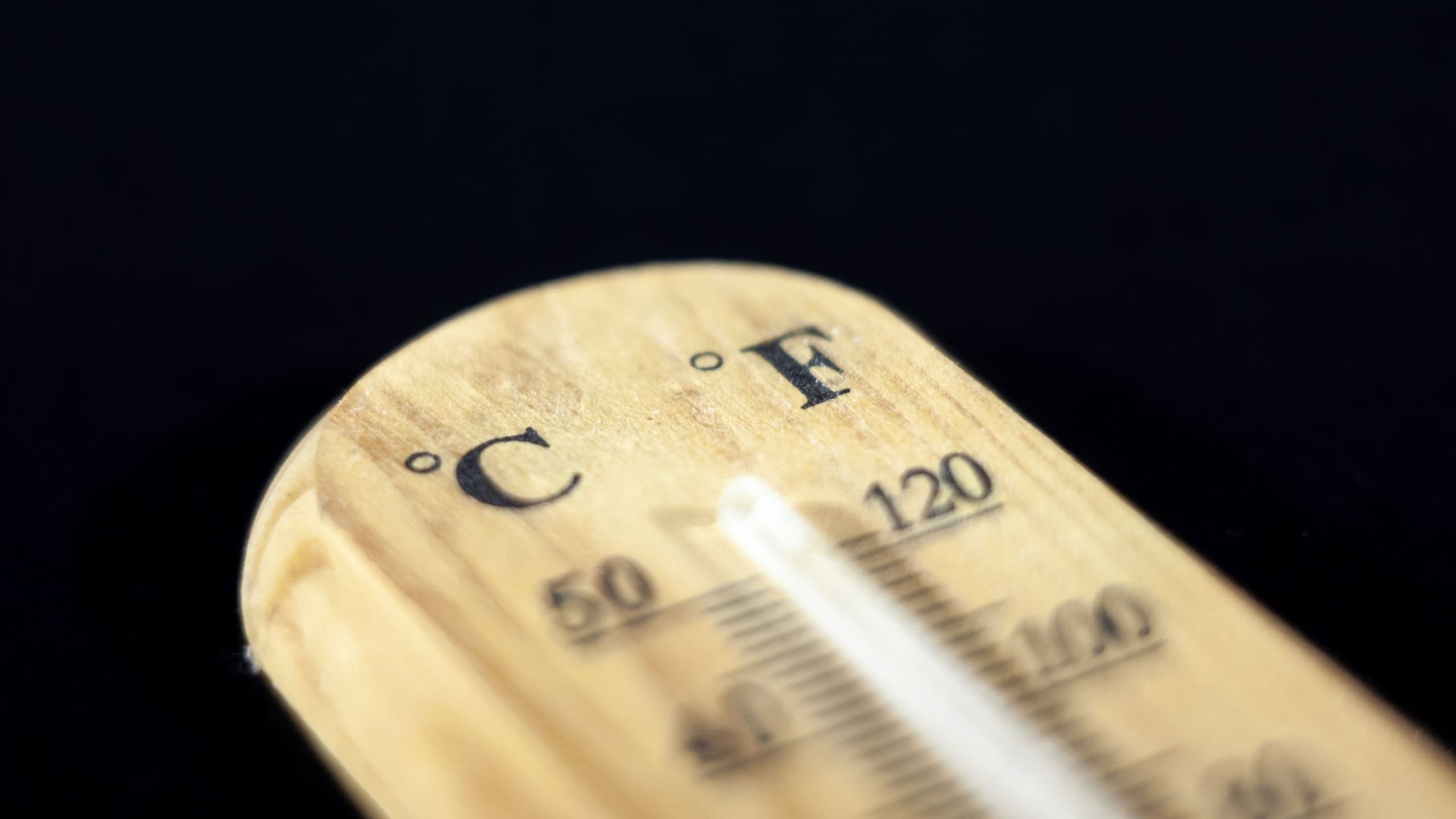 Selective focus on a thermometer indicating the temperature both in Fahrenheit and Celsius degrees