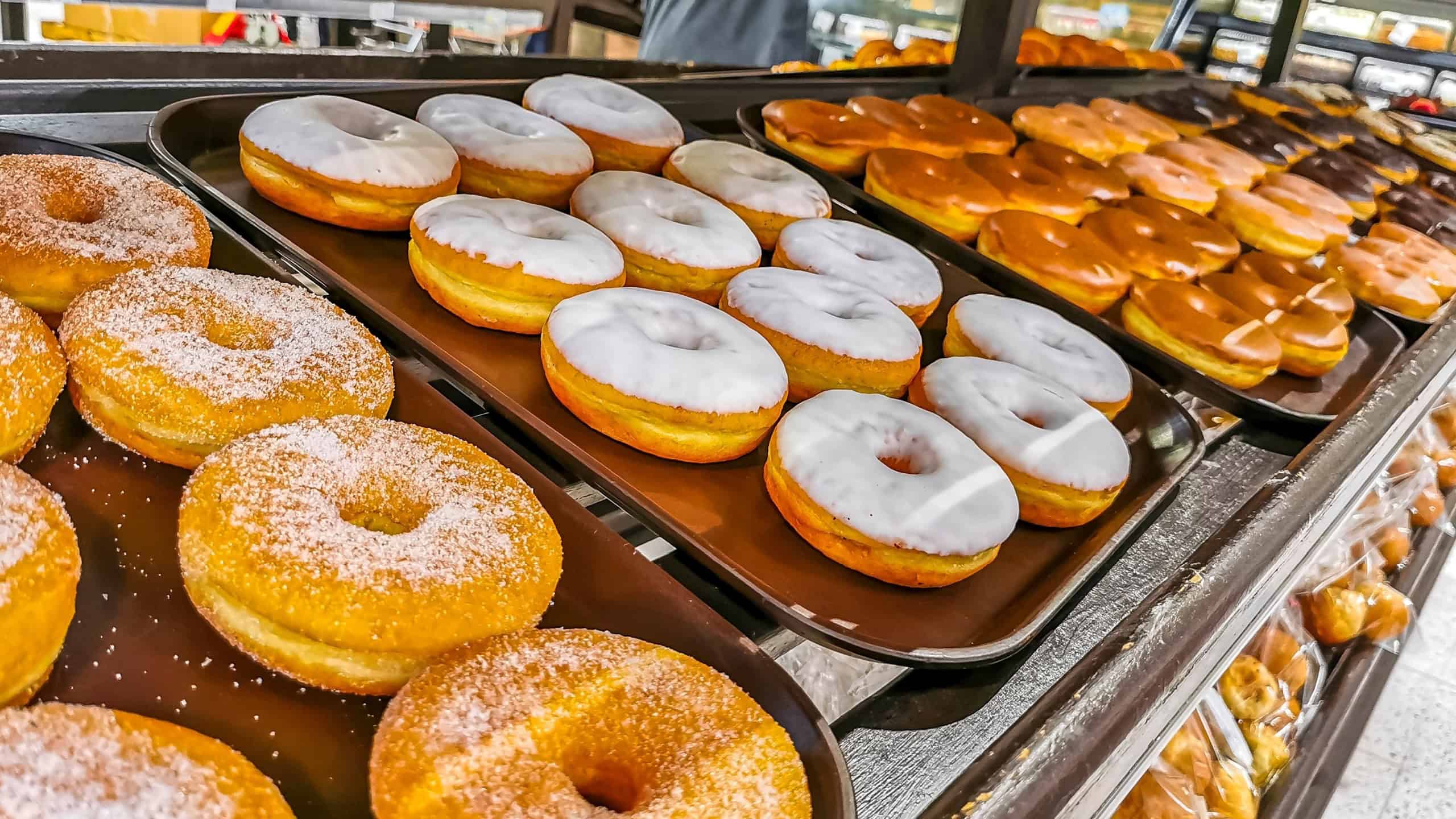 Chocolate and sugar donuts in supermarket bakery shelf