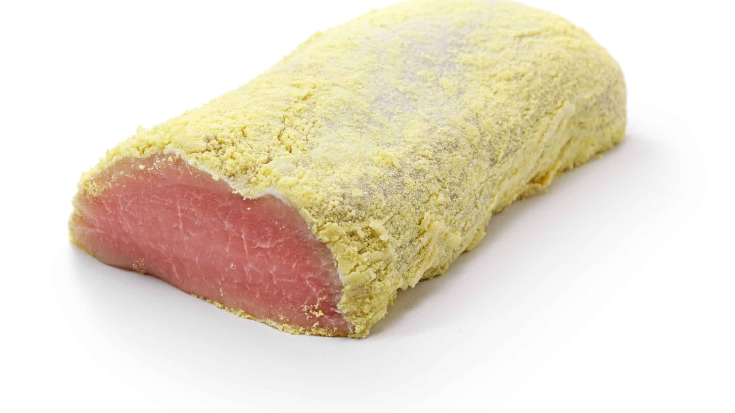 Homemade peameal bacon isolated on white background