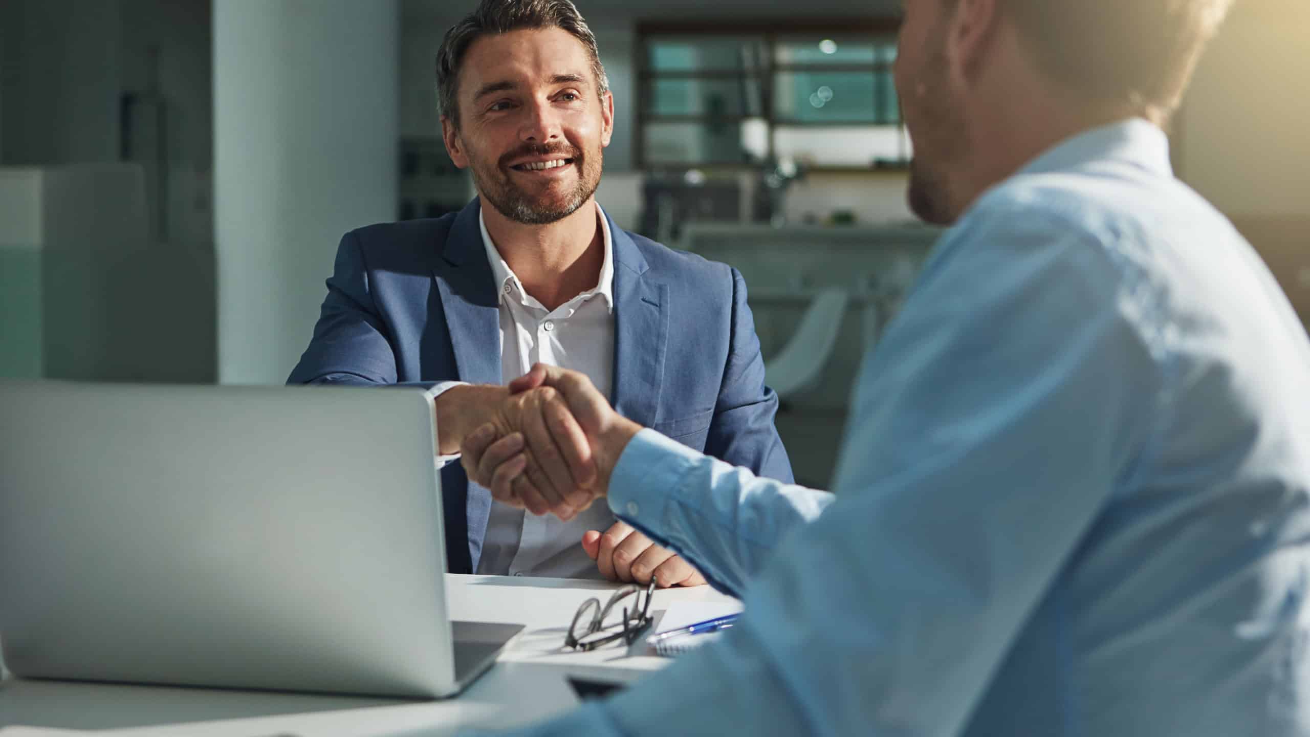 Business people, handshake and interview success or recruitment, employment and hiring in office. Corporate, men and executive shaking hands with new employee or collaboration on deal or partnership