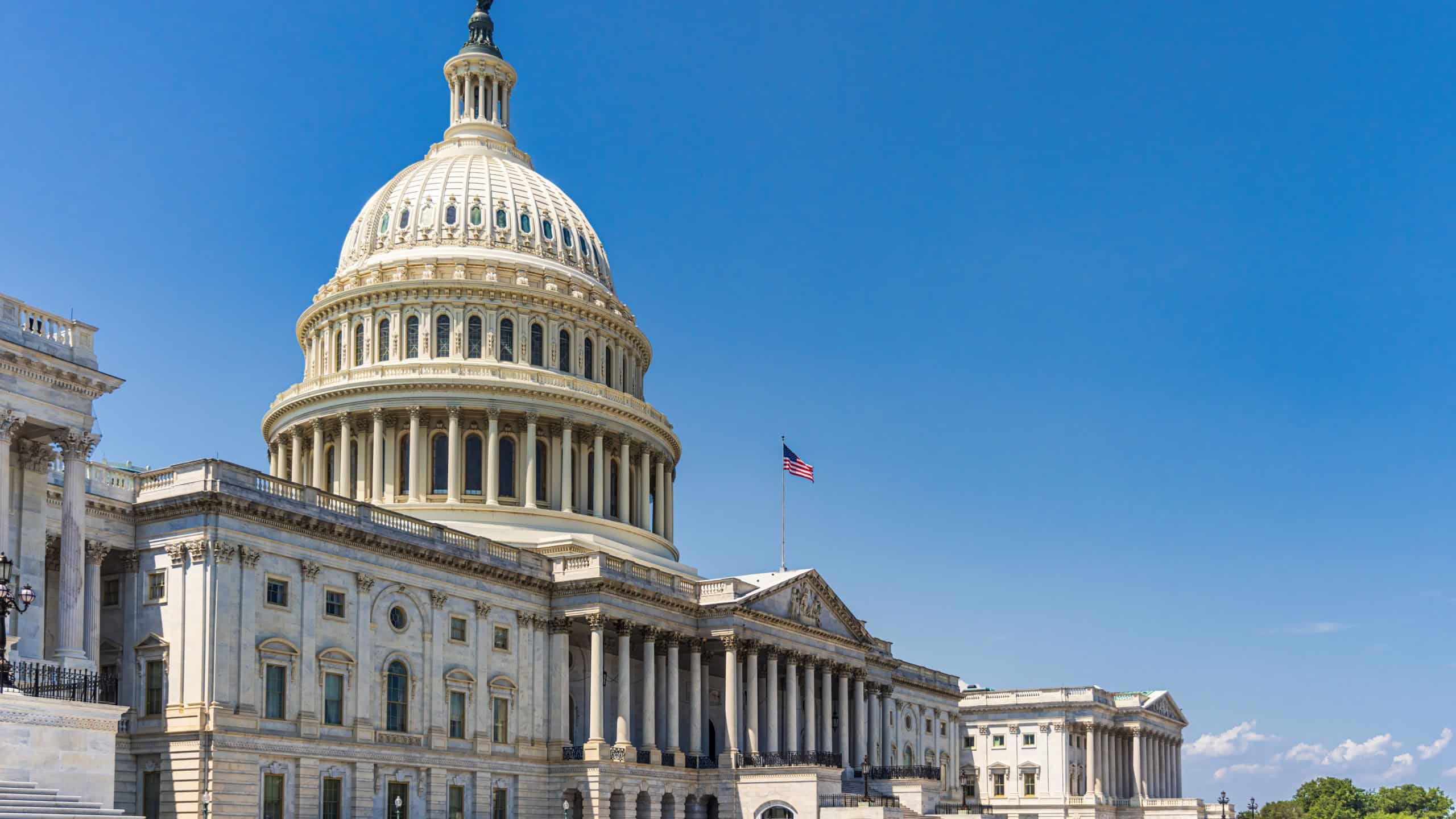 The United States Capitol building with American flag, Washington DC, USA.