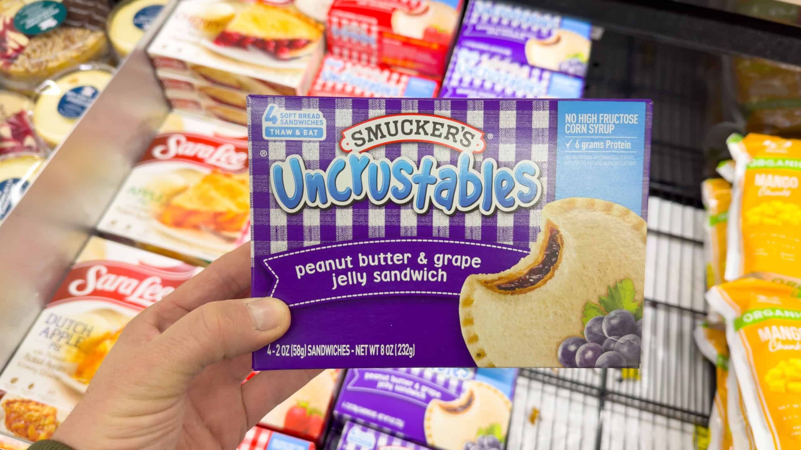 Los Angeles, CA - October 28, 2023: Smuckers Uncrustables peanut butter and grape jelly sandwich. Frozen treats for any time.