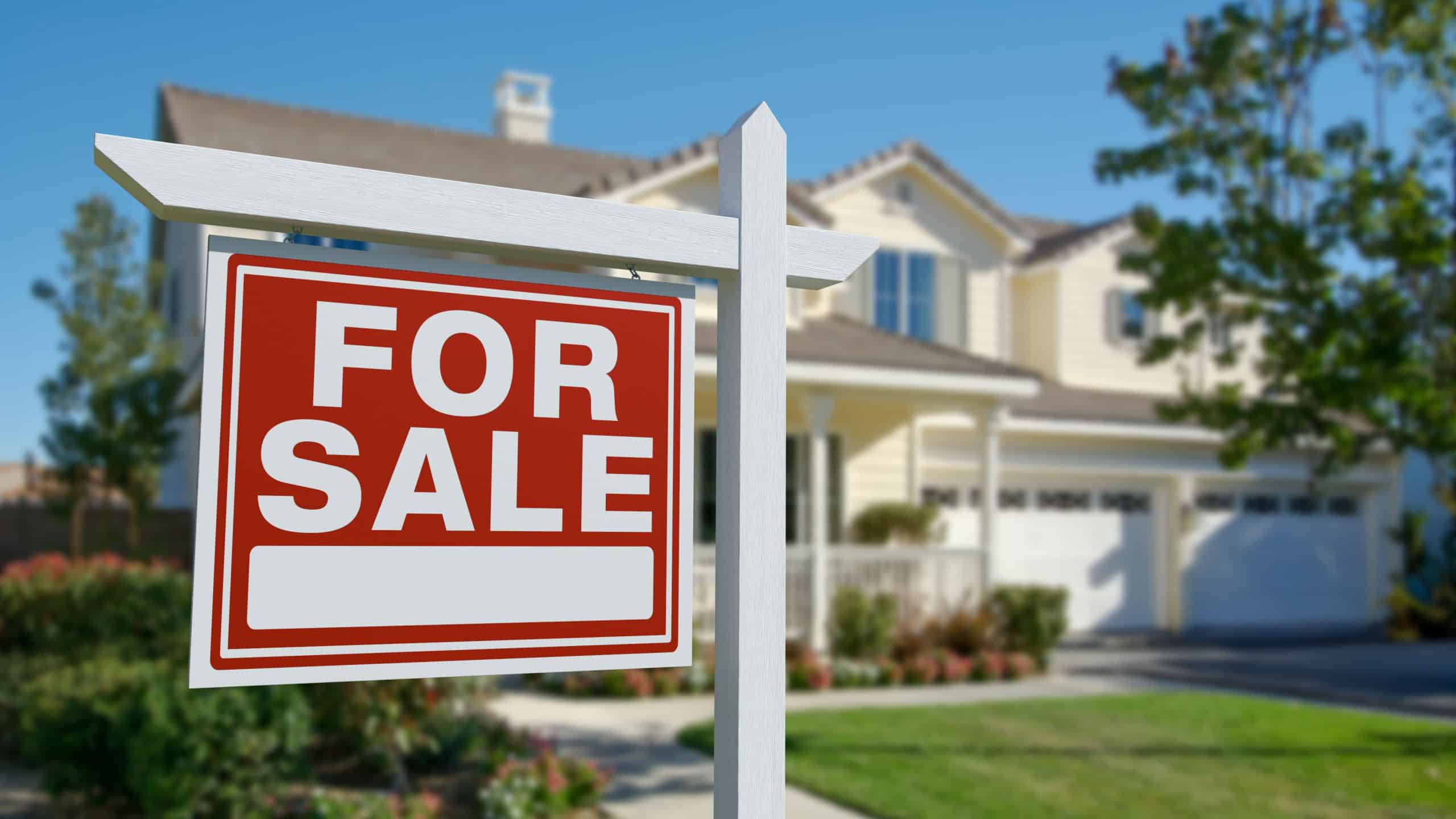 For Sale Real Estate Sign in Front of Beautiful House.