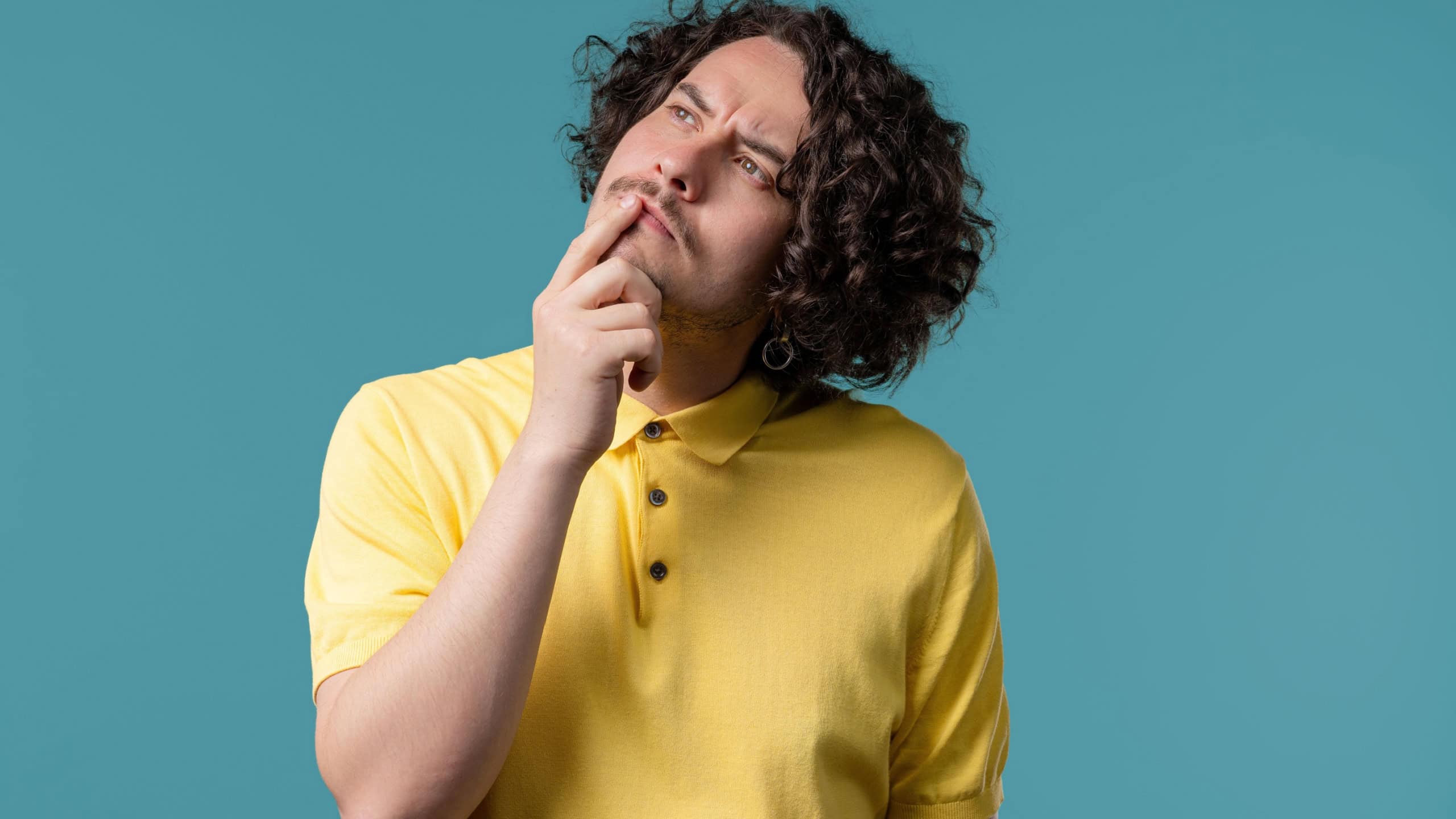 Worried thinking around hipster american man on blue. Confused student guy finding answer or trying to remember what he forgot, memory concept. High quality