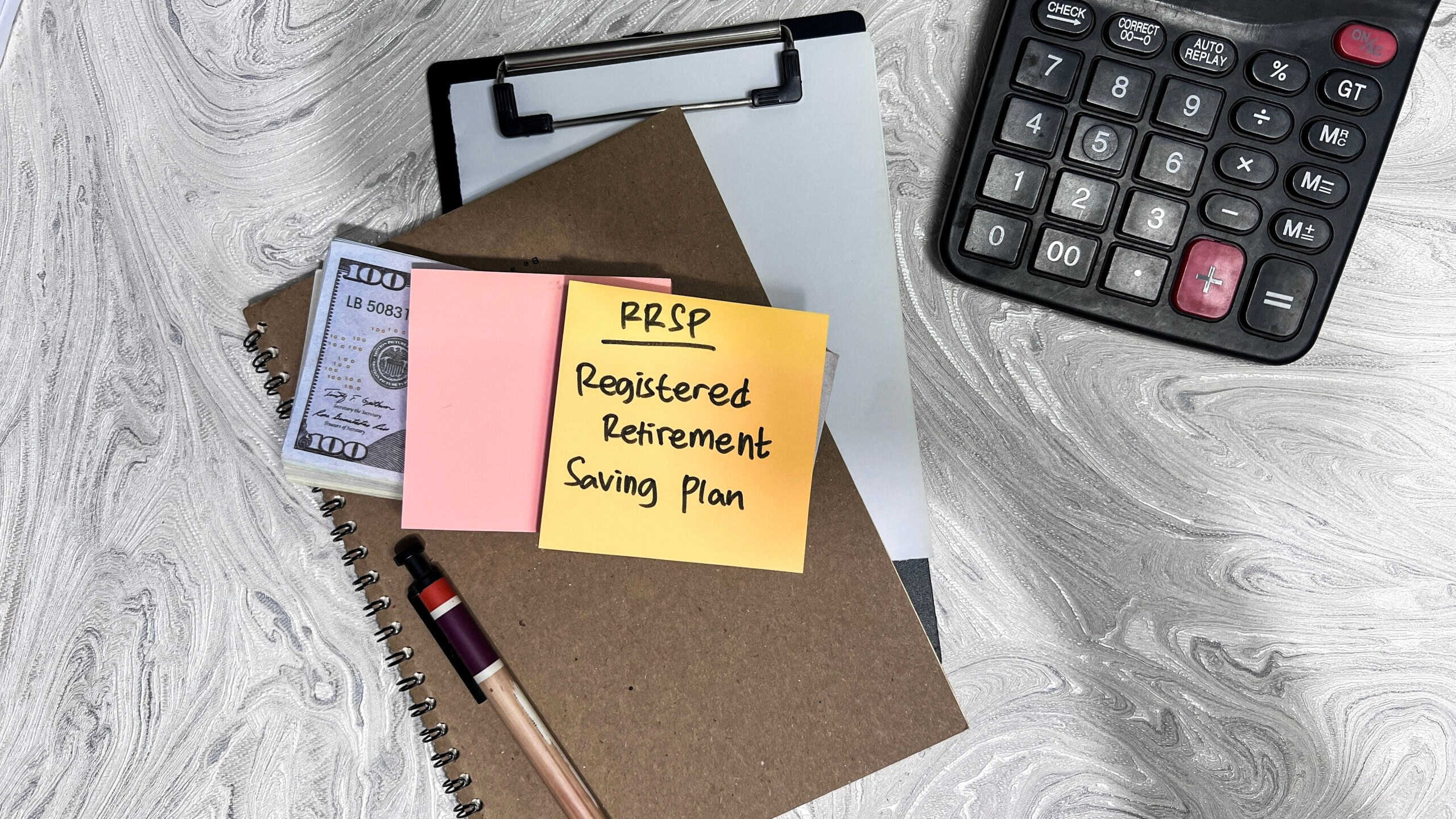 Concept of RRSP - Registered Retirement Saving Plan write on sticky notes isolated on Wooden Table.