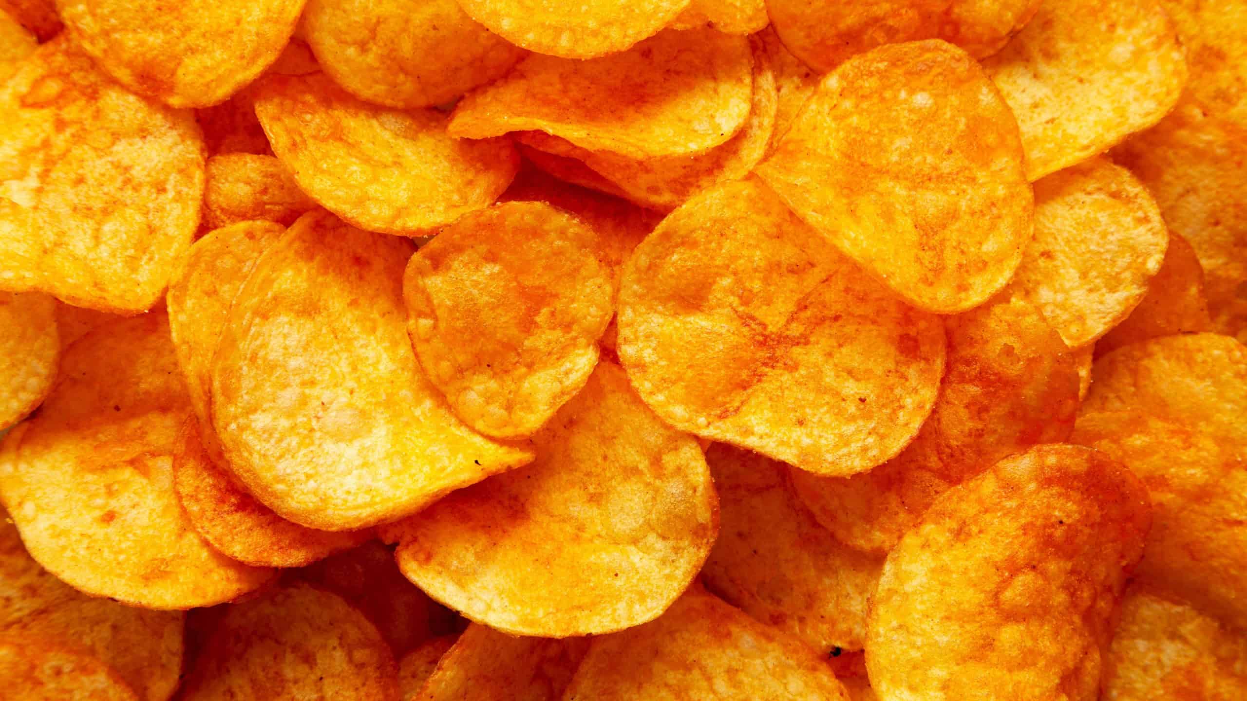 Homemade Flavored Paprika Potato Chips in a Bowl, top view. Flat lay, overhead, from above.