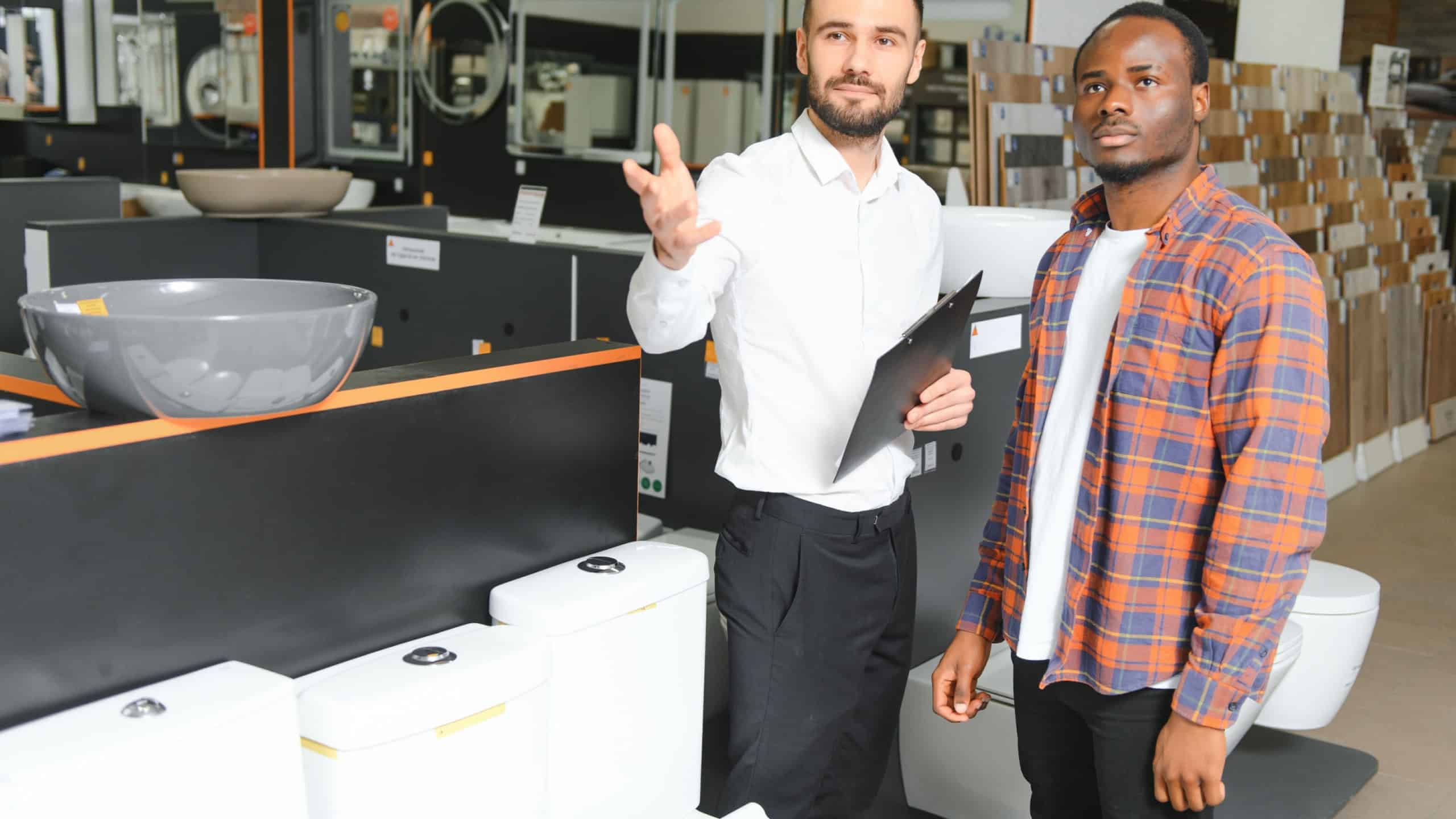 African man at the building market looking for sink into their bathroom.