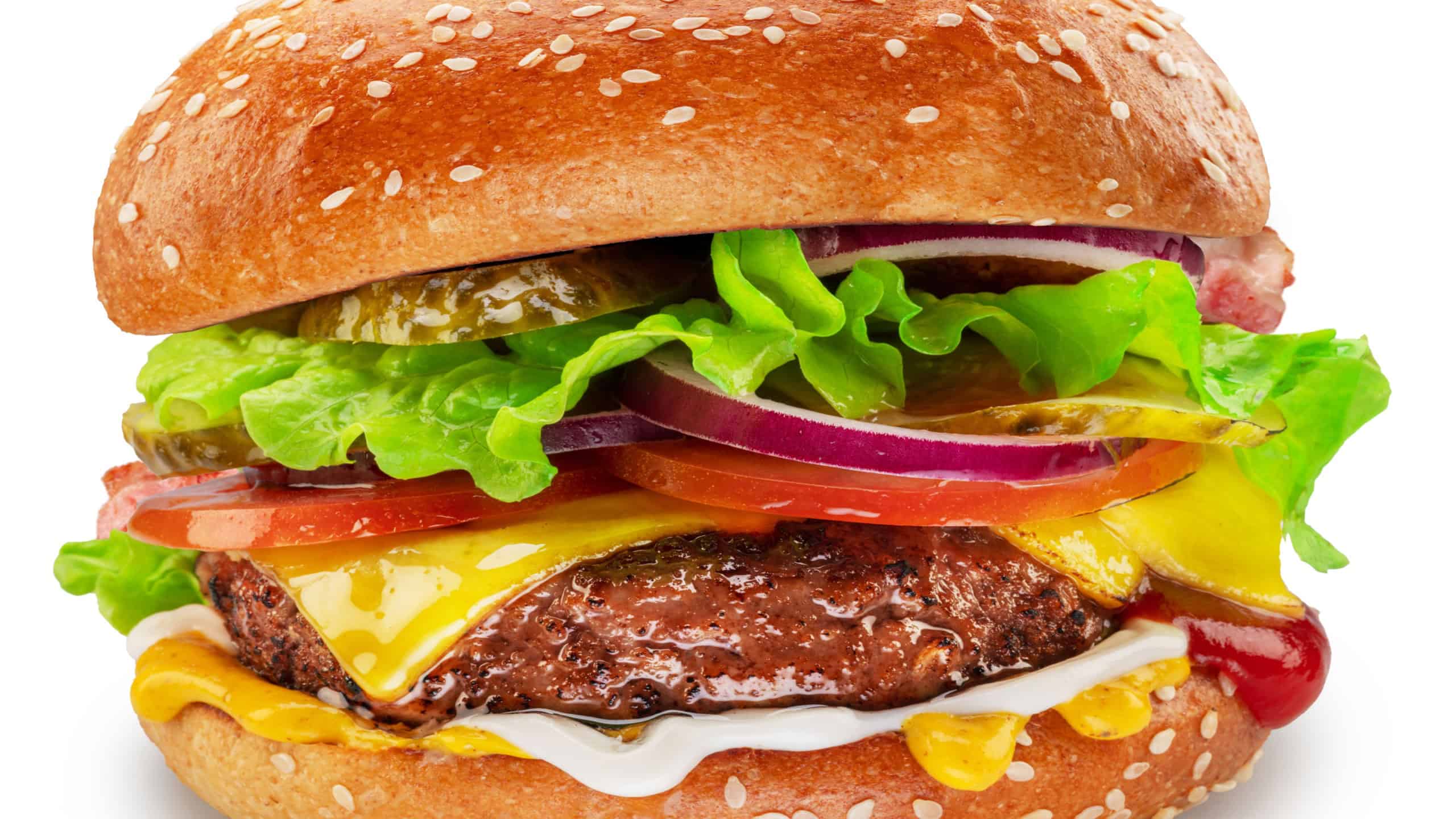 Beef patty hamburger with vegetables and cheese on white background.