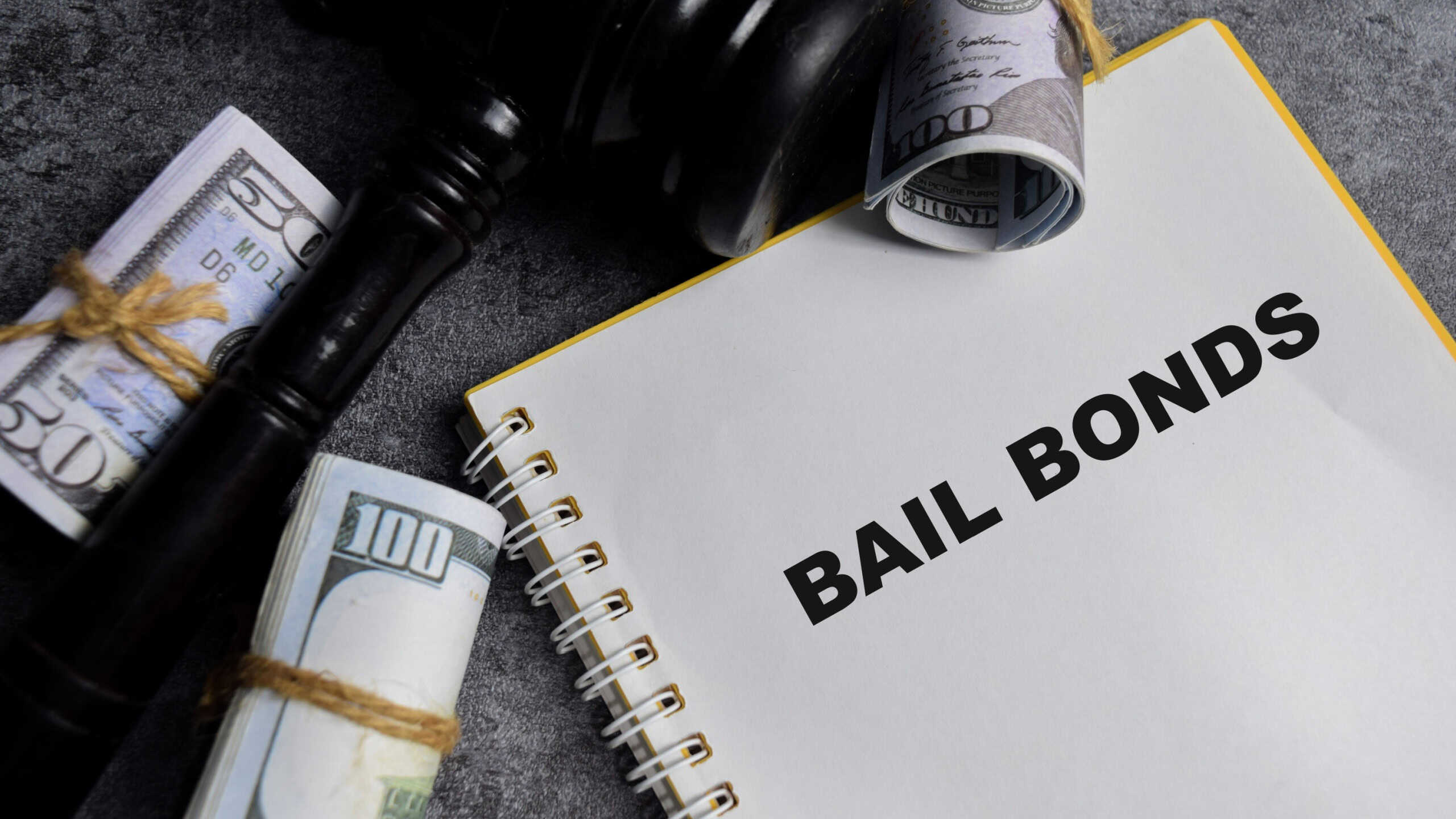 Concept of Bail Bonds write on book isolated on Wooden Table.