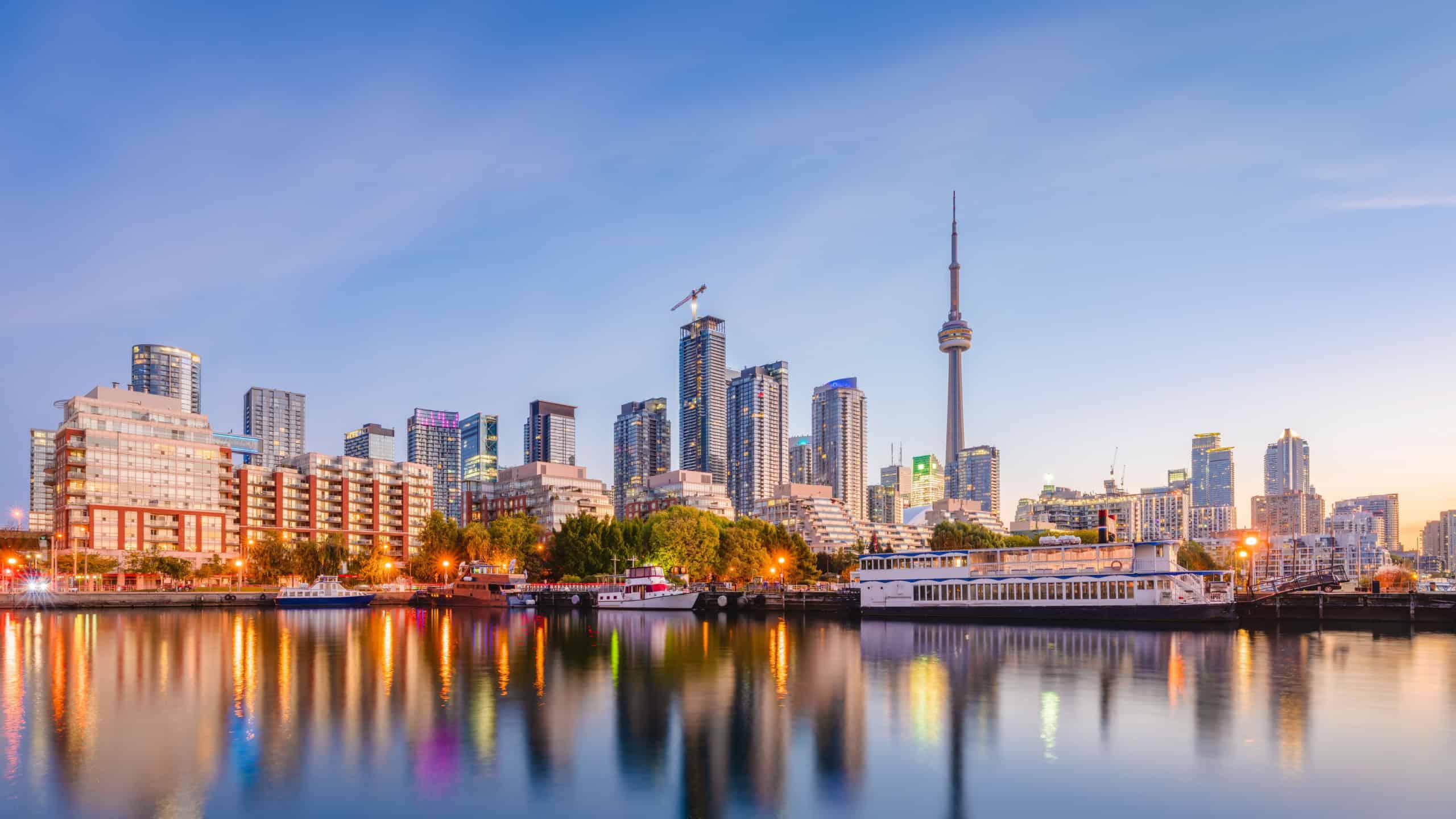Toronto, Ontario, Canada downtown city skyline on Lake Ontario at twilight.