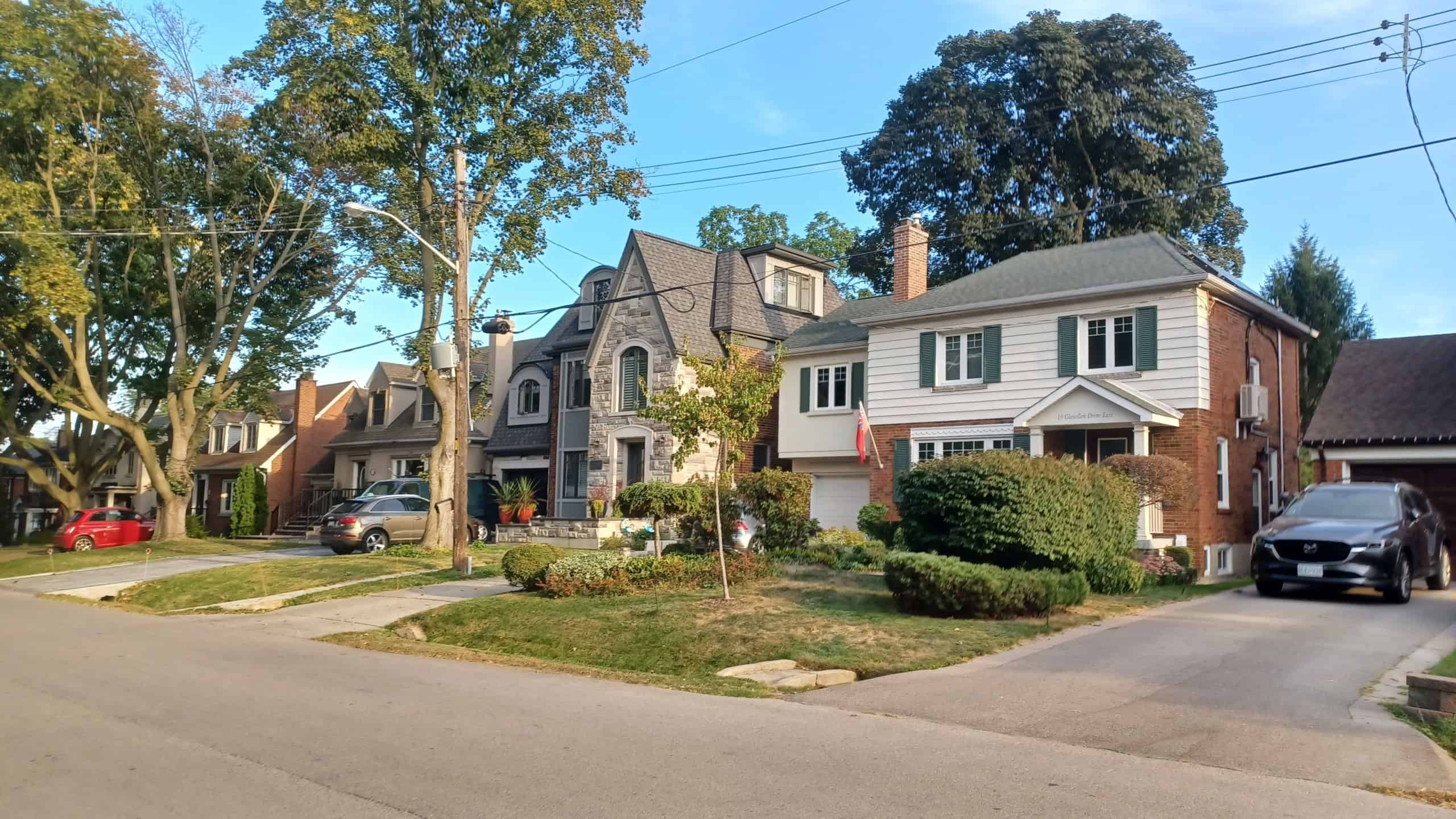 Toronto, ON, Canada - September 18, 2025: Traditional brick and siding residential houses stand side by side on a quiet neighborhood street.