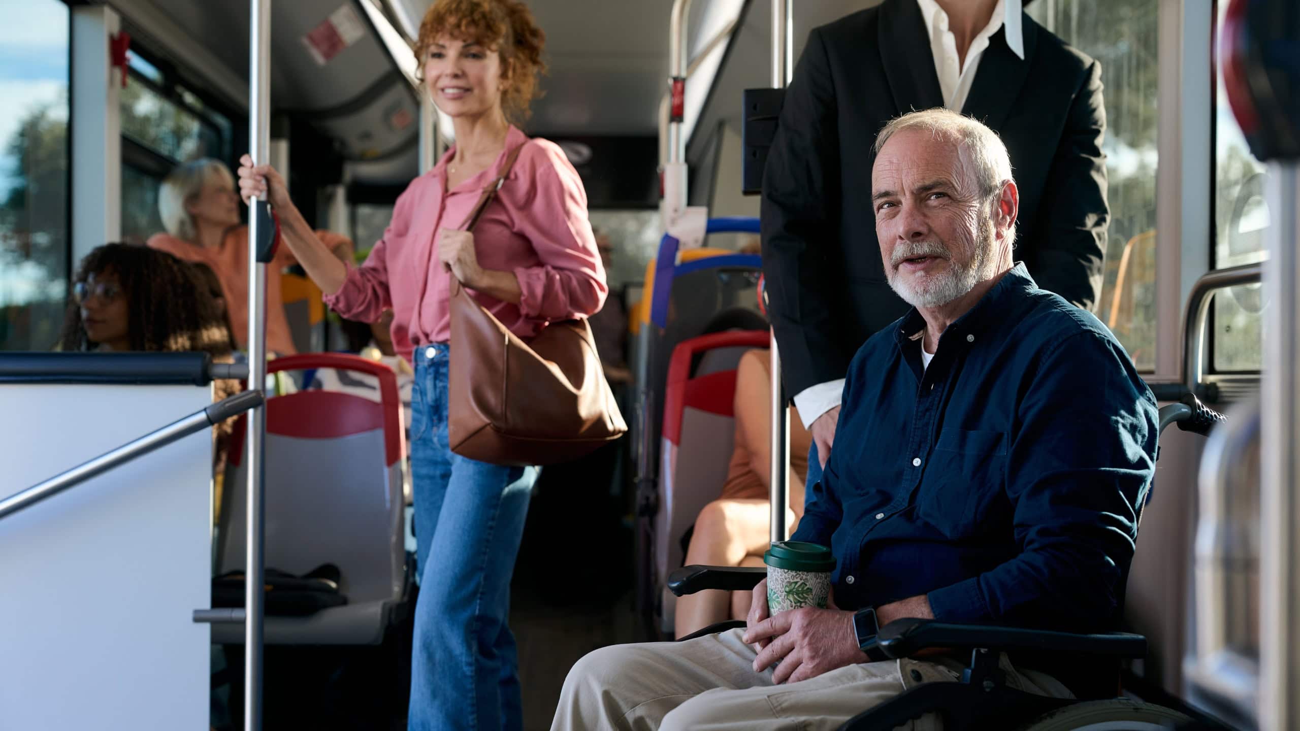 Senior man using wheelchair on public bus