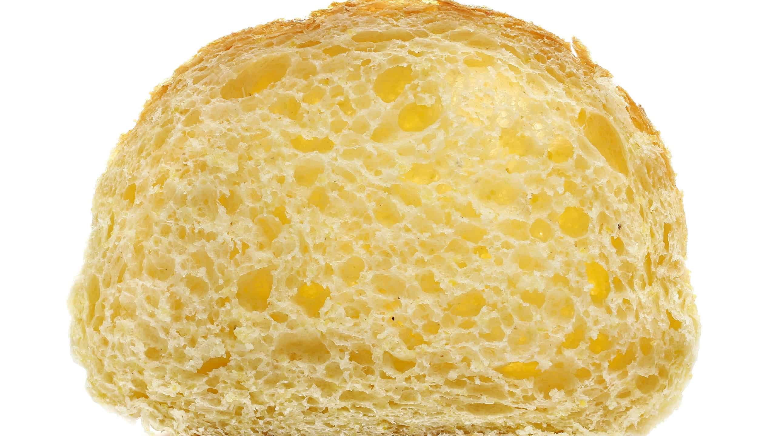 Fresh baked, slice of corn bread isolated on white background, side view