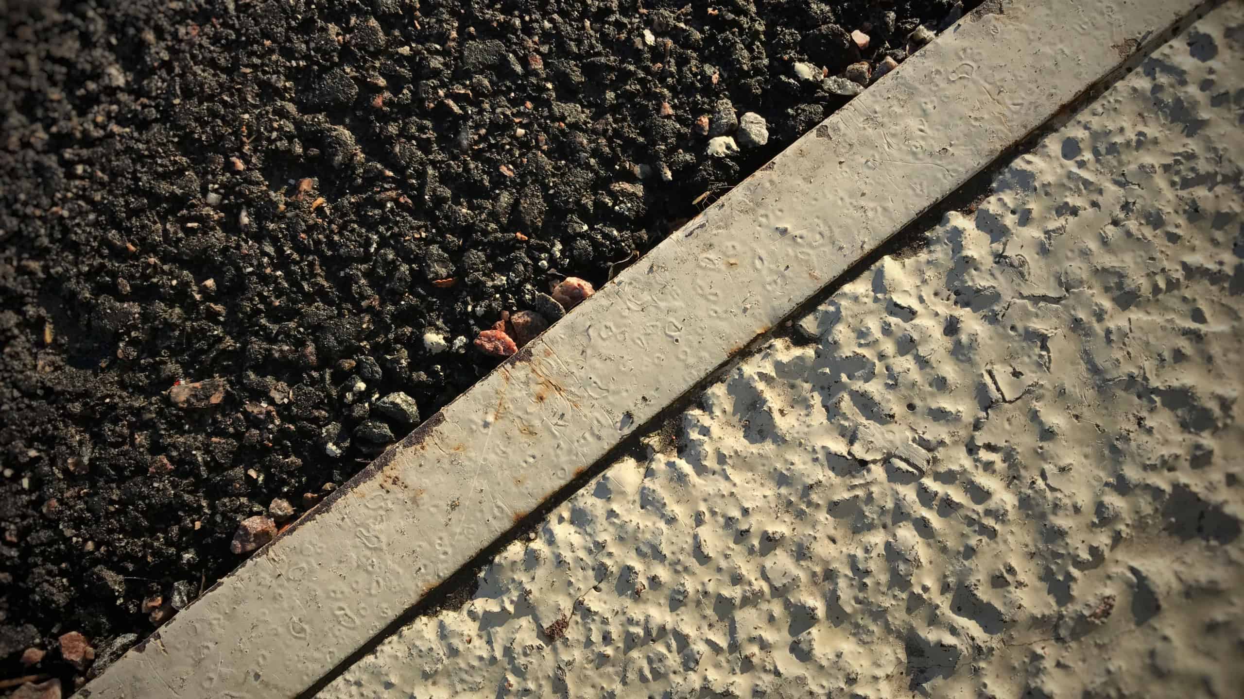 Asphalt vs. concrete. Closeup image from asphalt and concrete.