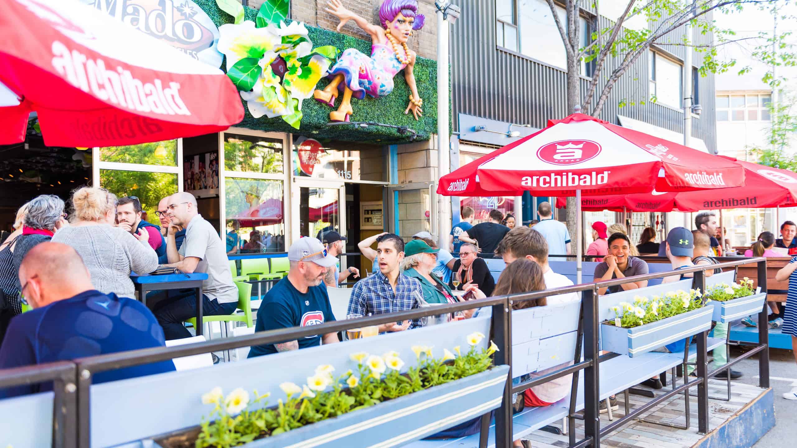 Montreal, Canada - May 27, 2017: People sitting at restaurant at table outside seating area in Gay Village neighborhood at city in Quebec region