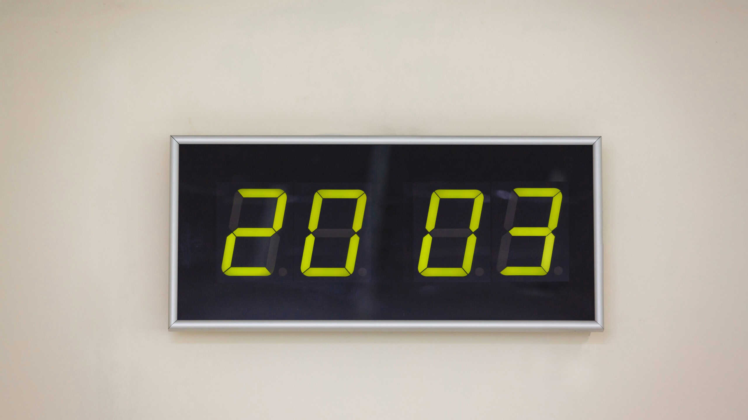 Black digital clock on a white background showing time