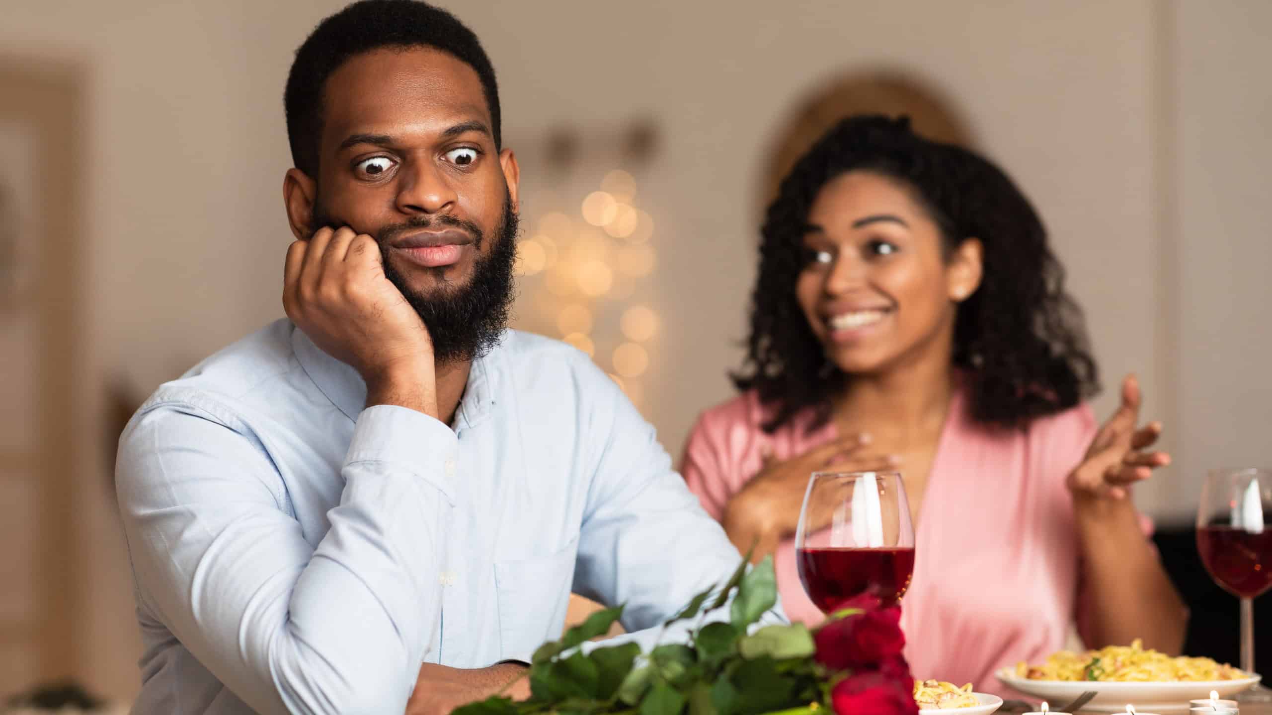 Bad First Impression And Date Concept. Dissatisfied shocked black man listening to excited emotional obsessed woman talking, young couple sitting at table in cafe. Unpleasant conversation
