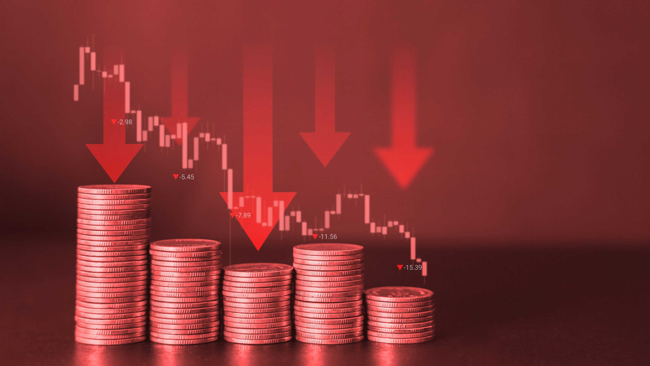 Red financial background with downward coin stack and down arrow with trading graph. Significantly deteriorated developing global recession concept.