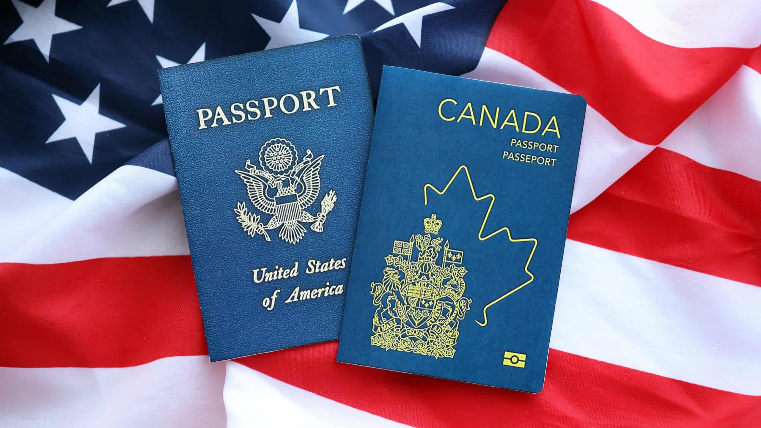 Passport of Canada with US Passport on United States of America folded flag close up