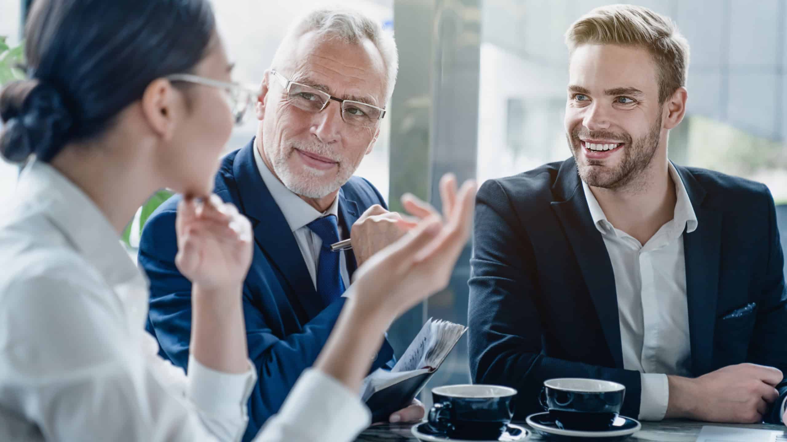 Startup business team on meeting in modern bright office. Group of multiracial business people, talking, planning startup, sharing ideas, cooperation working together