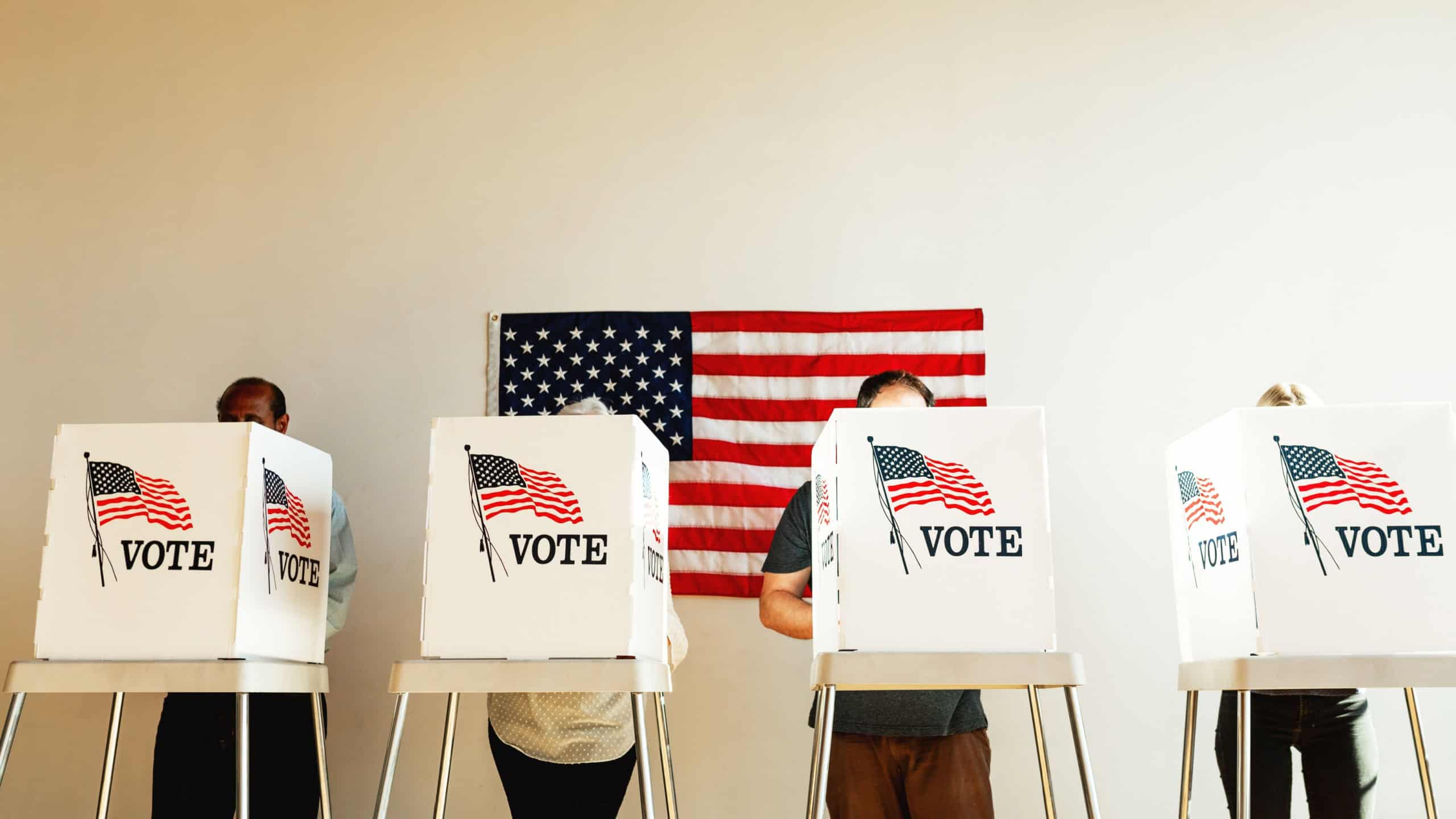 US election day, Diverse people at voting booth at US election station with American flag in background. Diverse people in line to vote at US election day. Vote for American democracy.