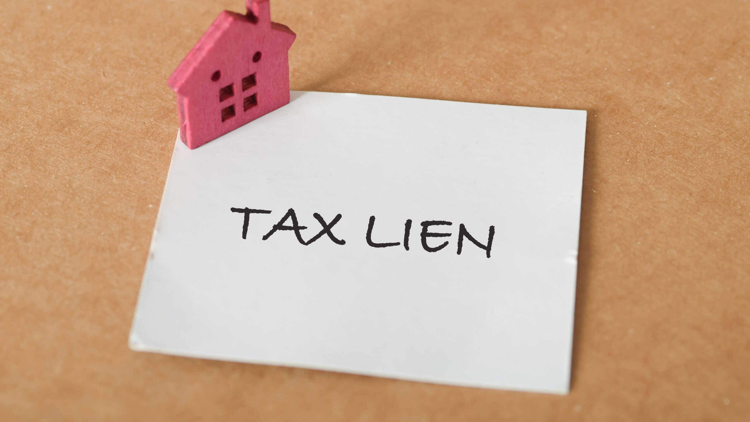 House and Tax Lien Note Representing Financial Burden and Legal Implications in Property Taxation