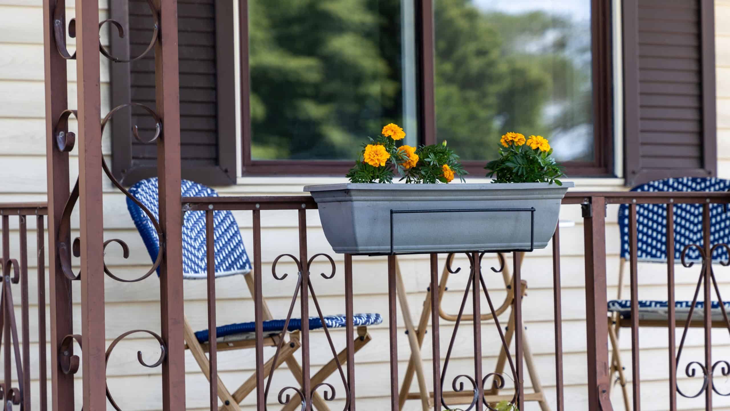 Summer porch with outdoor furniture and potted flowers