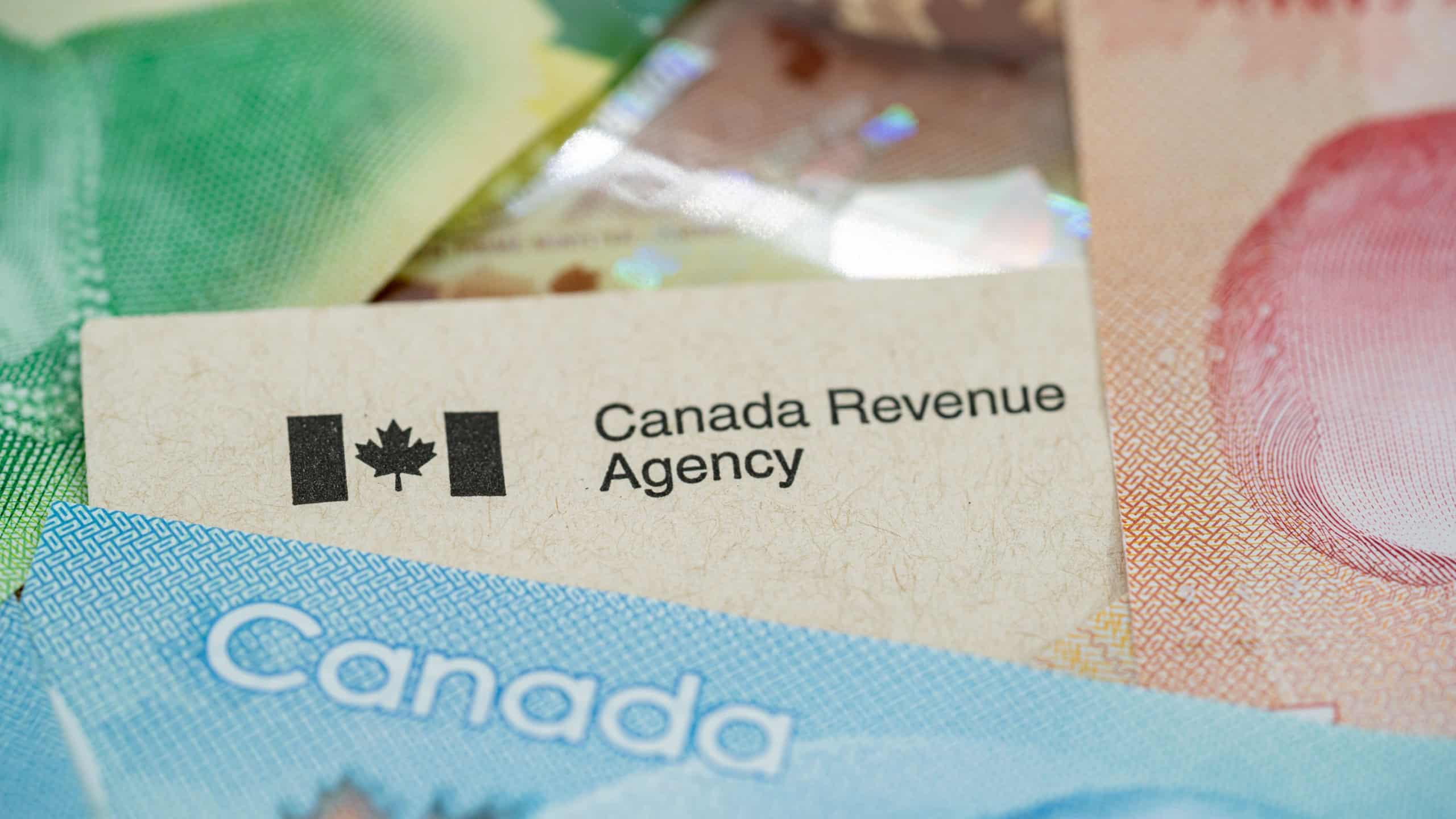 Close up of Canada Revenue Agency document with Canadian banknotes.
