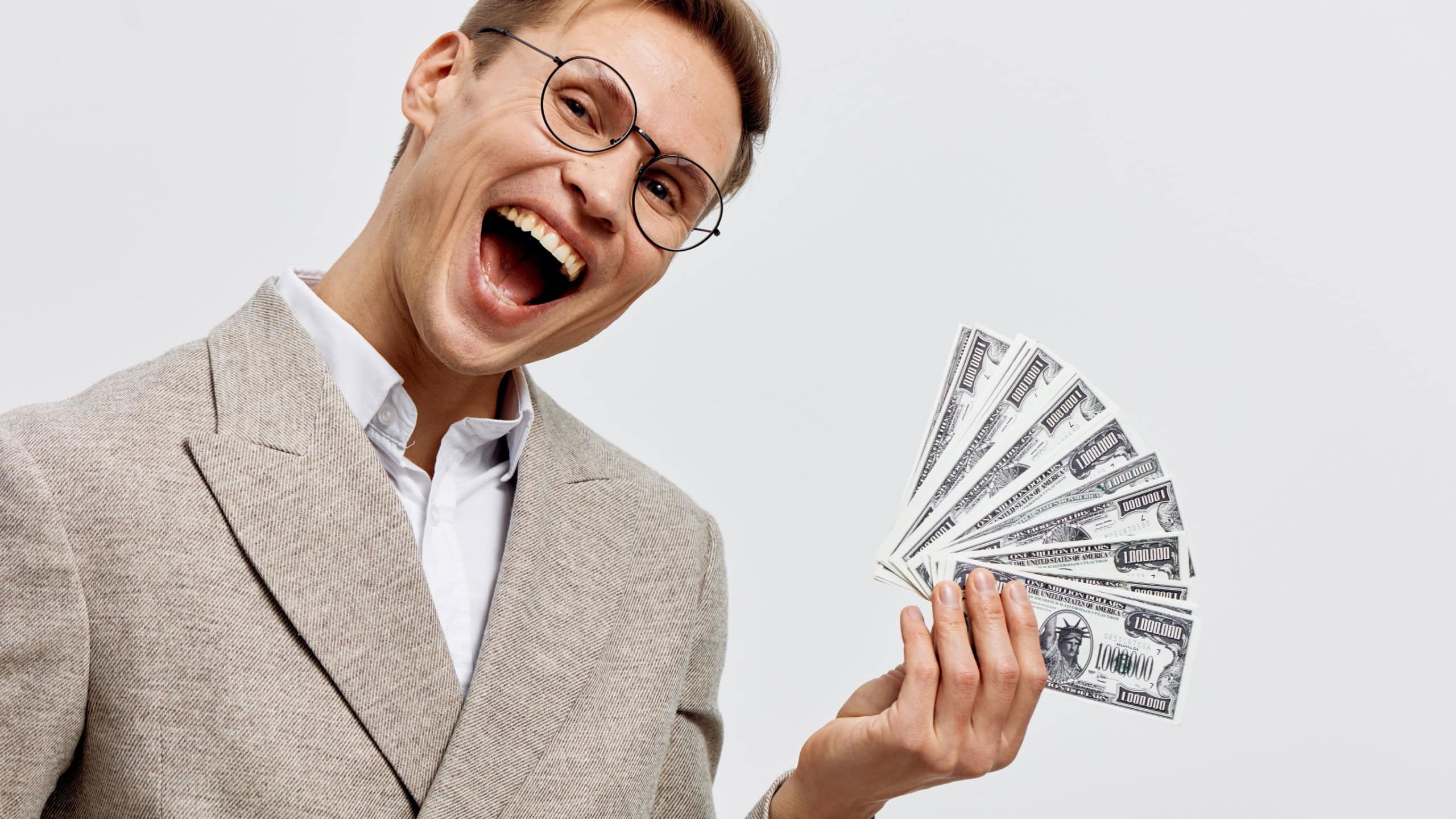 Confident smiling man in beige suit glasses holding fan of dollar bills