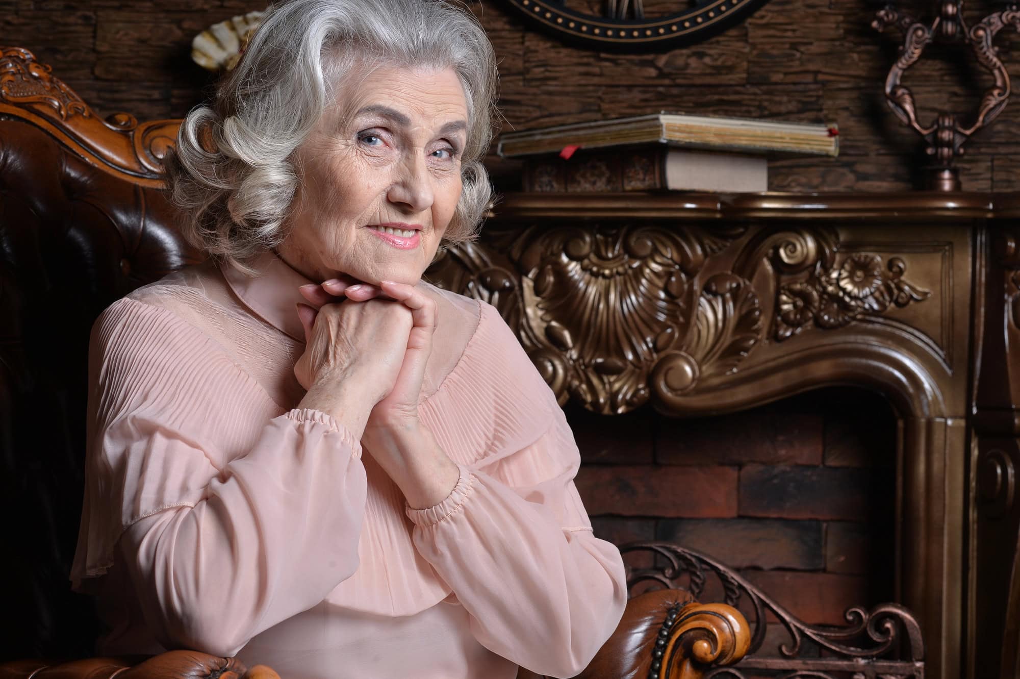 Portrait of happy senior woman in posing at home