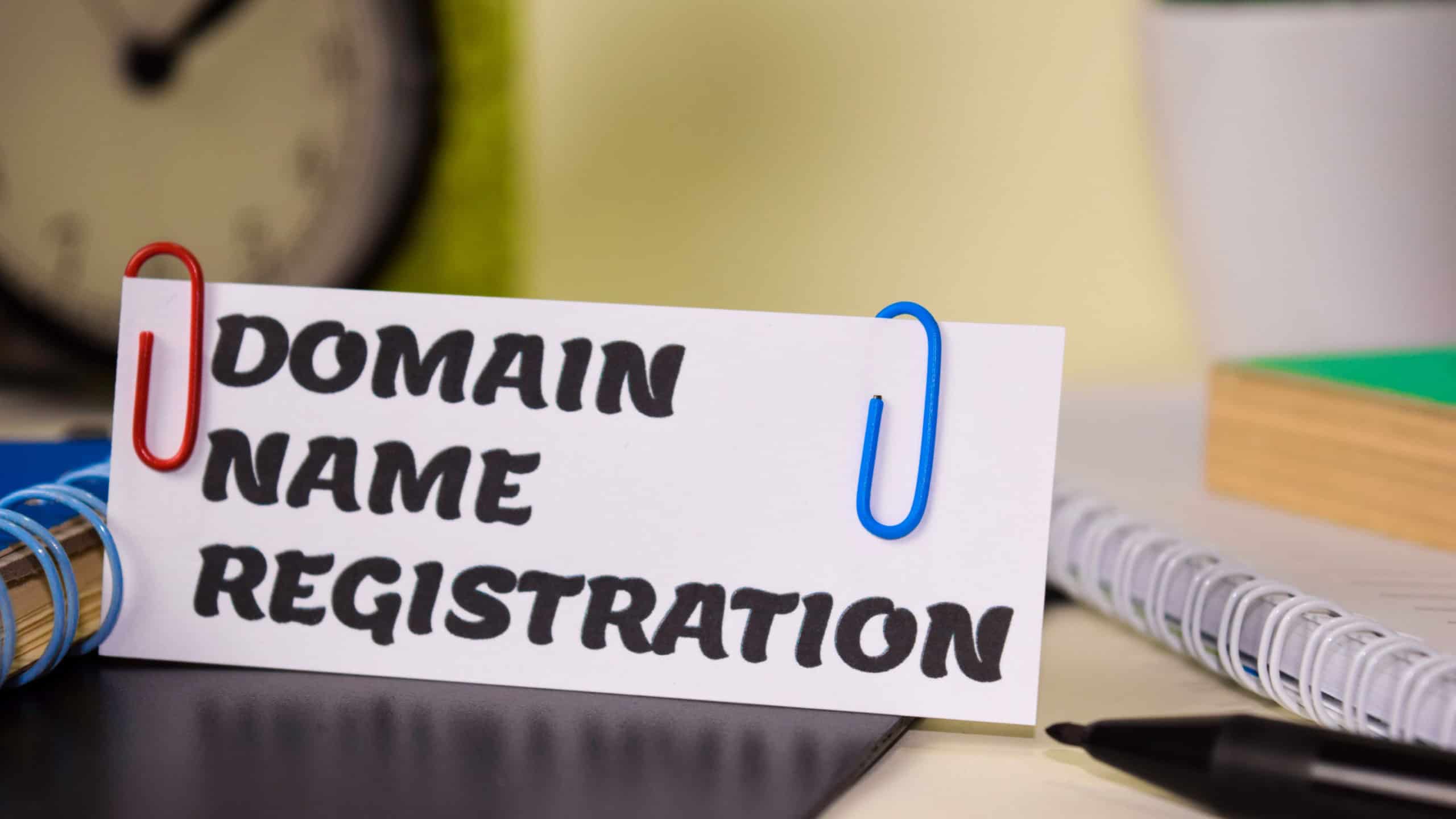 Domain Name Registration on the paper isolated on it desk. Business and inspiration concept