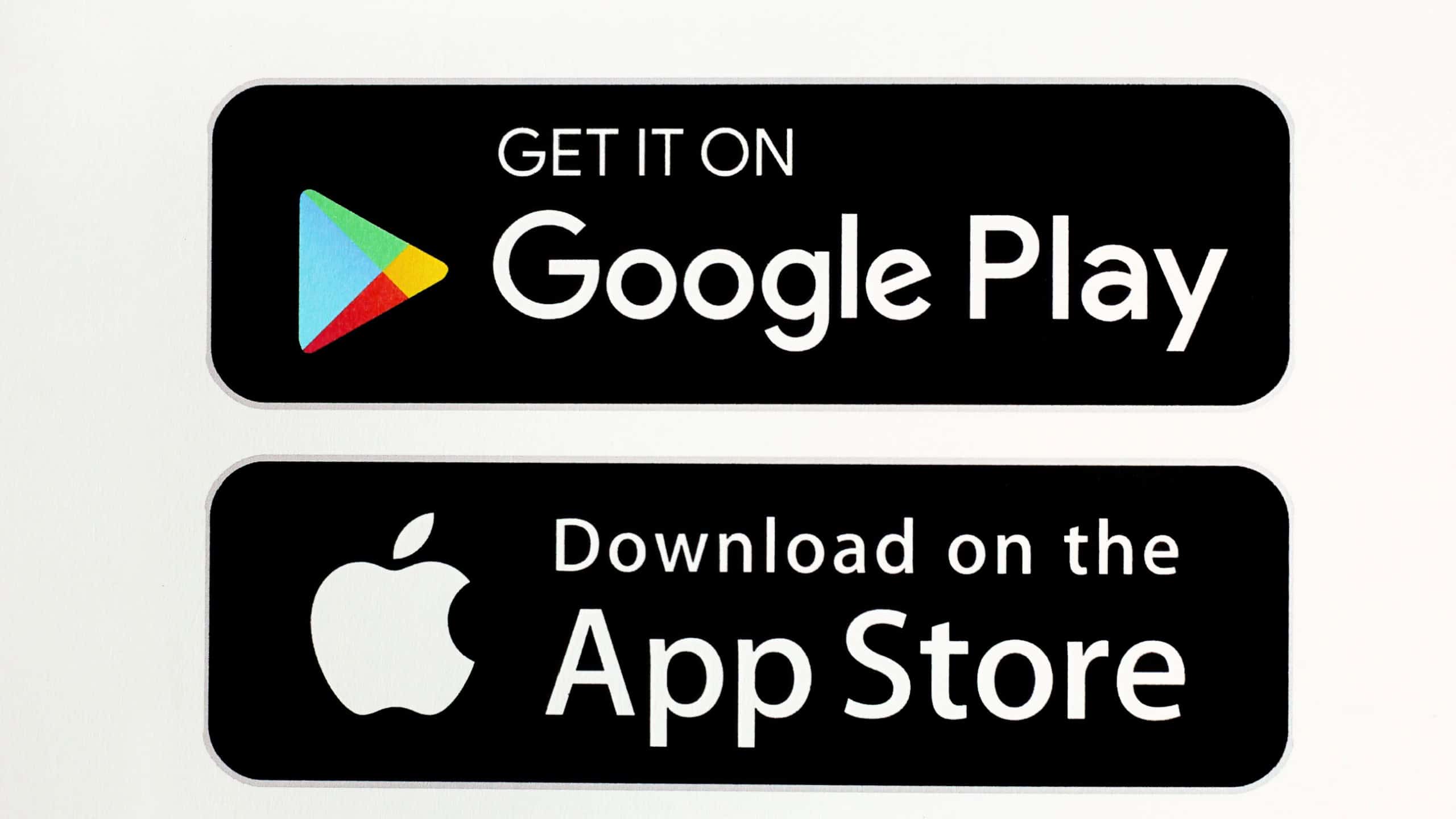 Bahawalpur, Pakistan - July 14, 2021: Download on the App Store and Get it on Google Play button icons, printed on paper