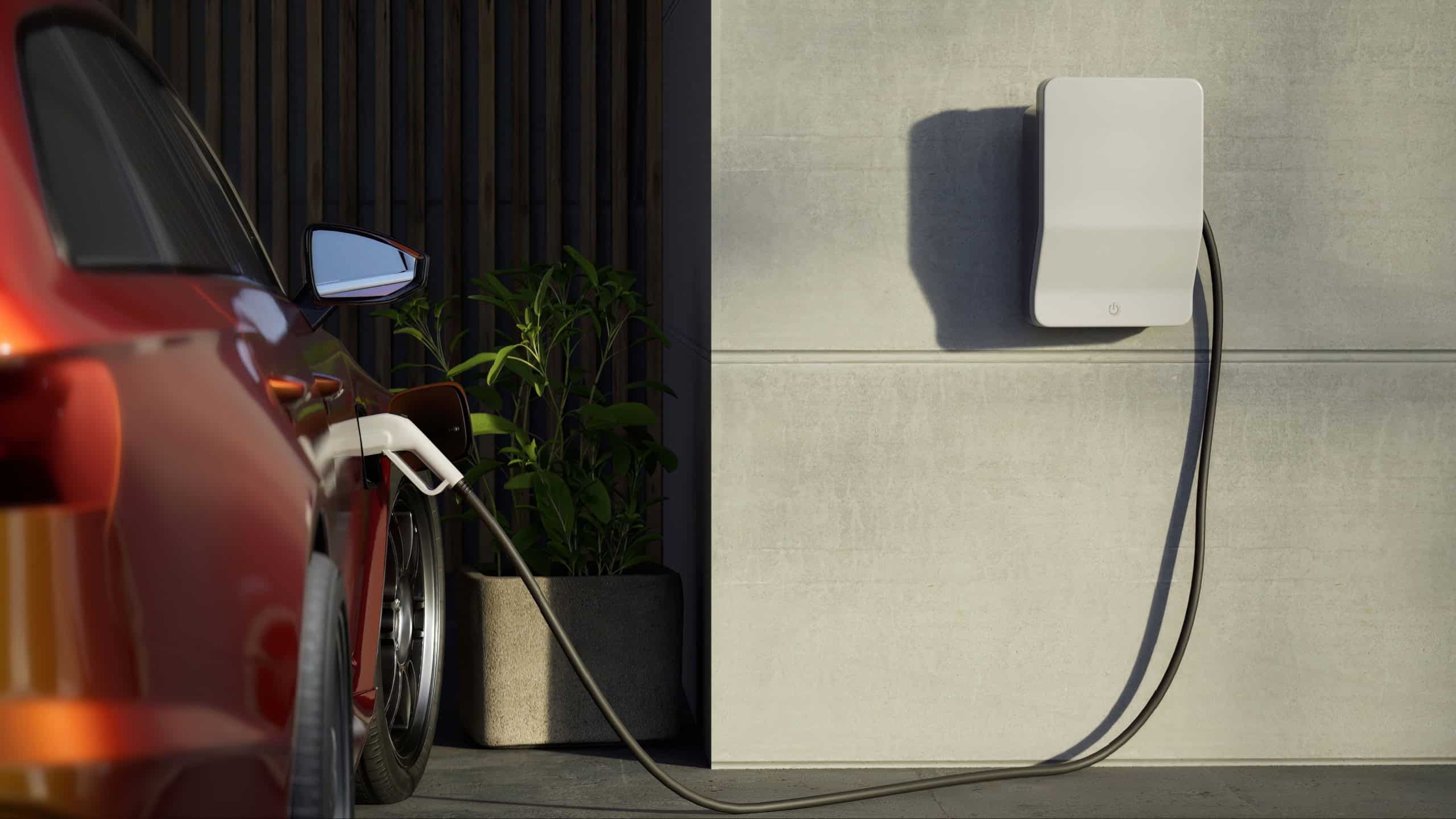 Generic electric vehicle EV hybrid car is being charged from a wallbox on a contemporary modern residential building house