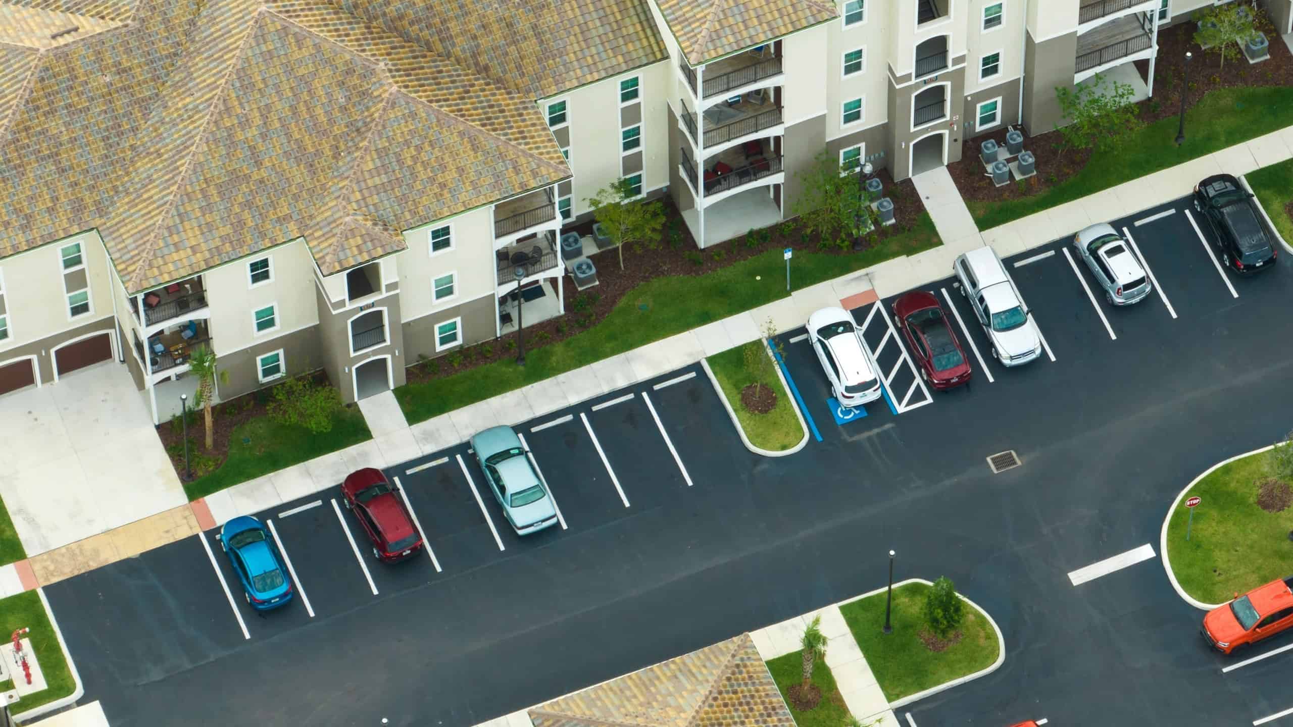 Apartment residential condos with car parking place in Florida suburban area. American condominiums as example of real estate development in USA suburbs