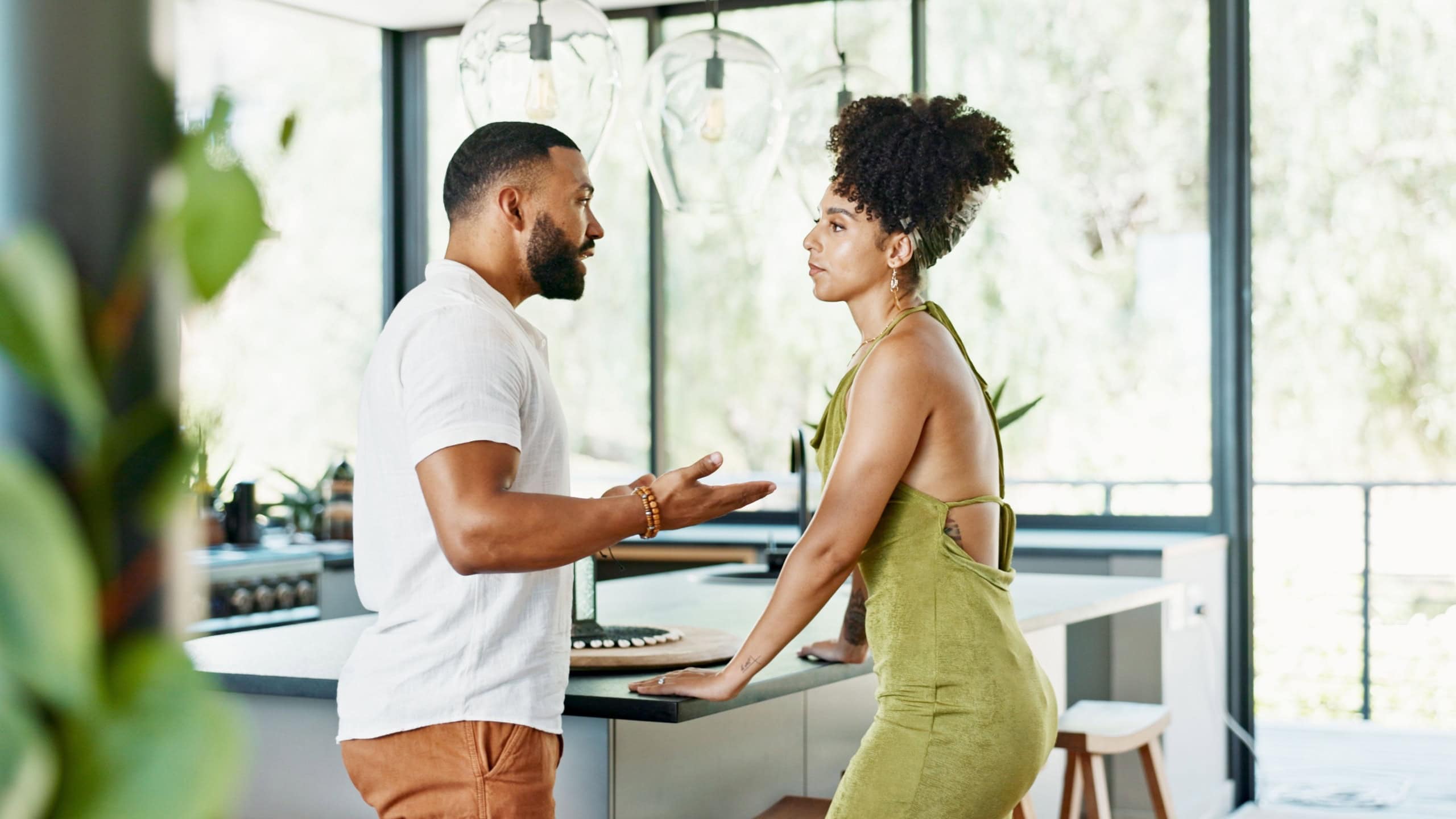 Divorce, crisis and couple argue in a kitchen with stress, anger and cheating confrontation at home. Marriage, conflict or frustrated people in a house with doubt, disaster or gaslighting disaster