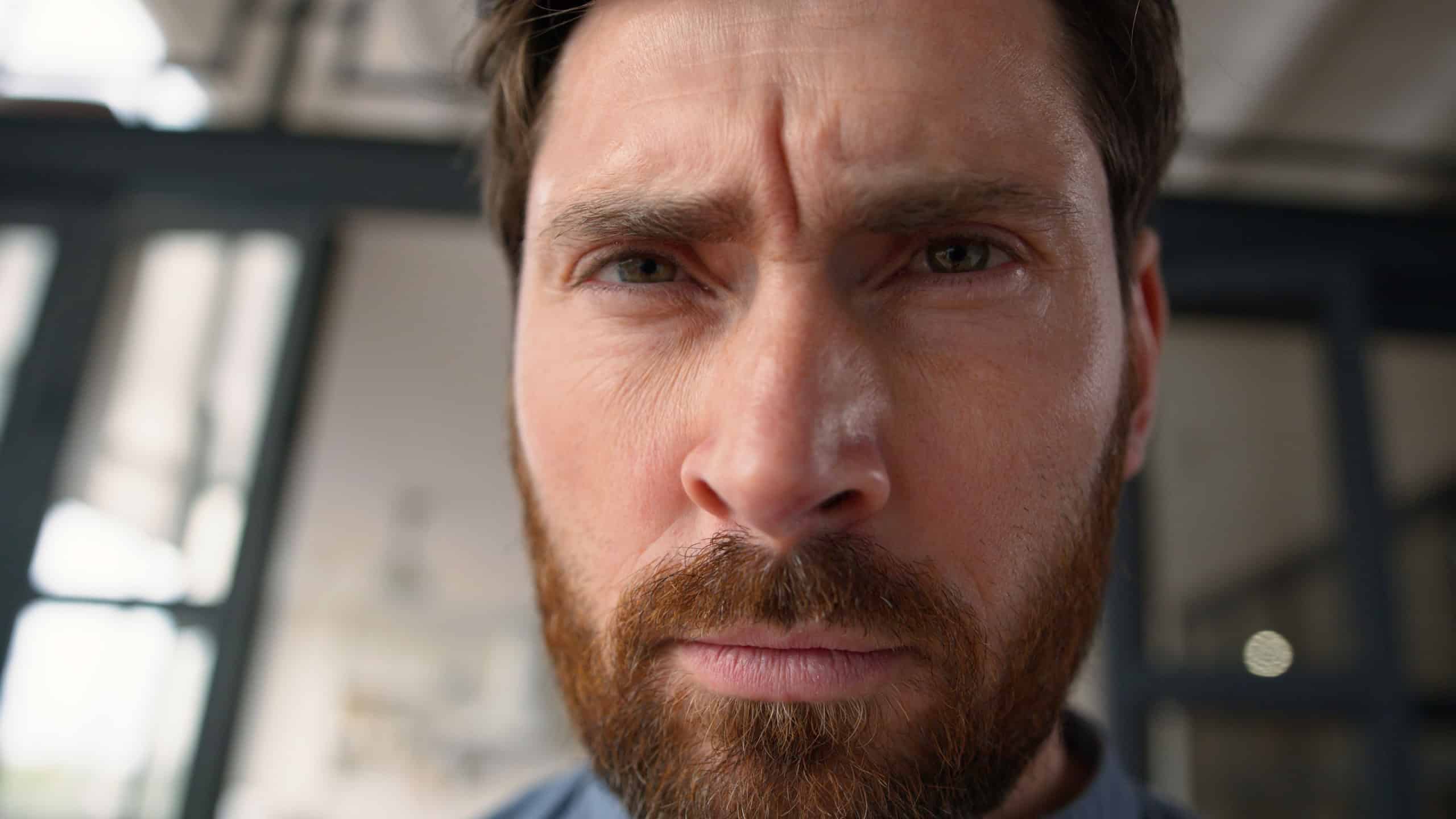 Frustrated Caucasian guy male man close up portrait pensive middle-aged parent looking at camera at home serious stressed thoughtful facial expression dad portrait mortgage problem adult father crisis